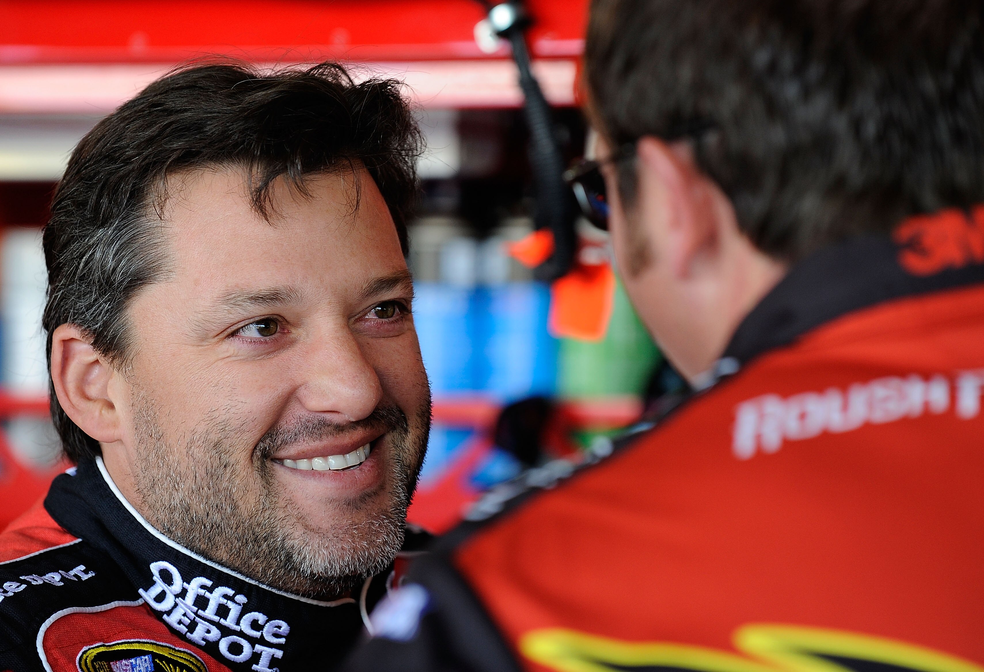 AVONDALE, AZ - NOVEMBER 13:  Tony Stewart, driver of the #14 Old Spice/Office Depot Chevrolet, stands in the garage during practice for the NASCAR Sprint Cup Series Kobalt Tools 500 at Phoenix International Raceway on November 13, 2010 in Avondale, Arizon