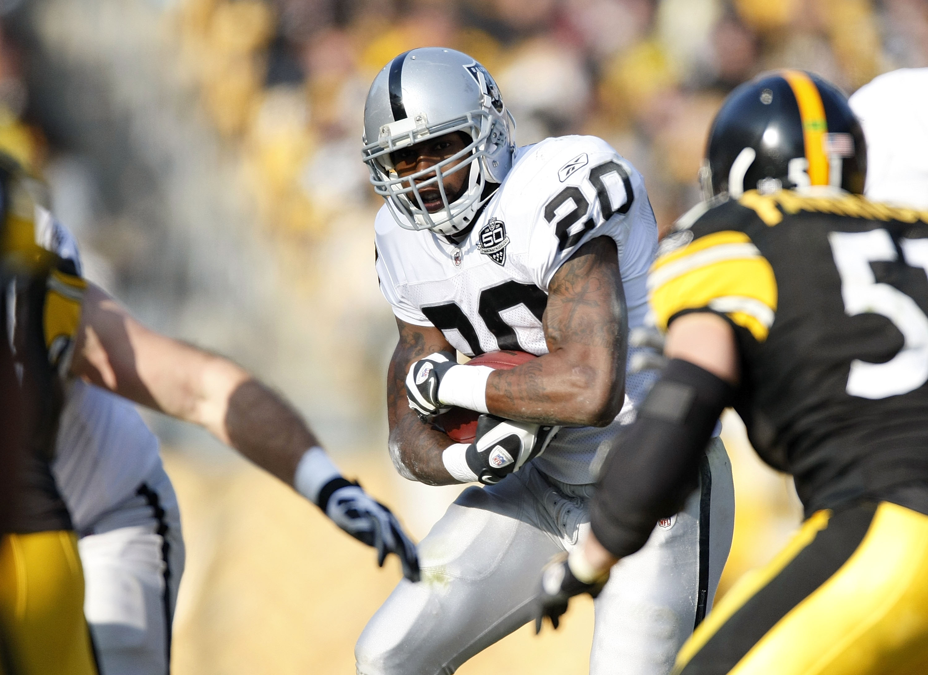 PITTSBURGH - DECEMBER 06:  Darren McFadden #20 of the Oakland Raiders looks for running room during a second quarter run while playing the Pittsburgh Steelrs on December 6, 2009 at Heinz Field in Pittsburgh, Pennsylvania.  (Photo by Gregory Shamus/Getty I