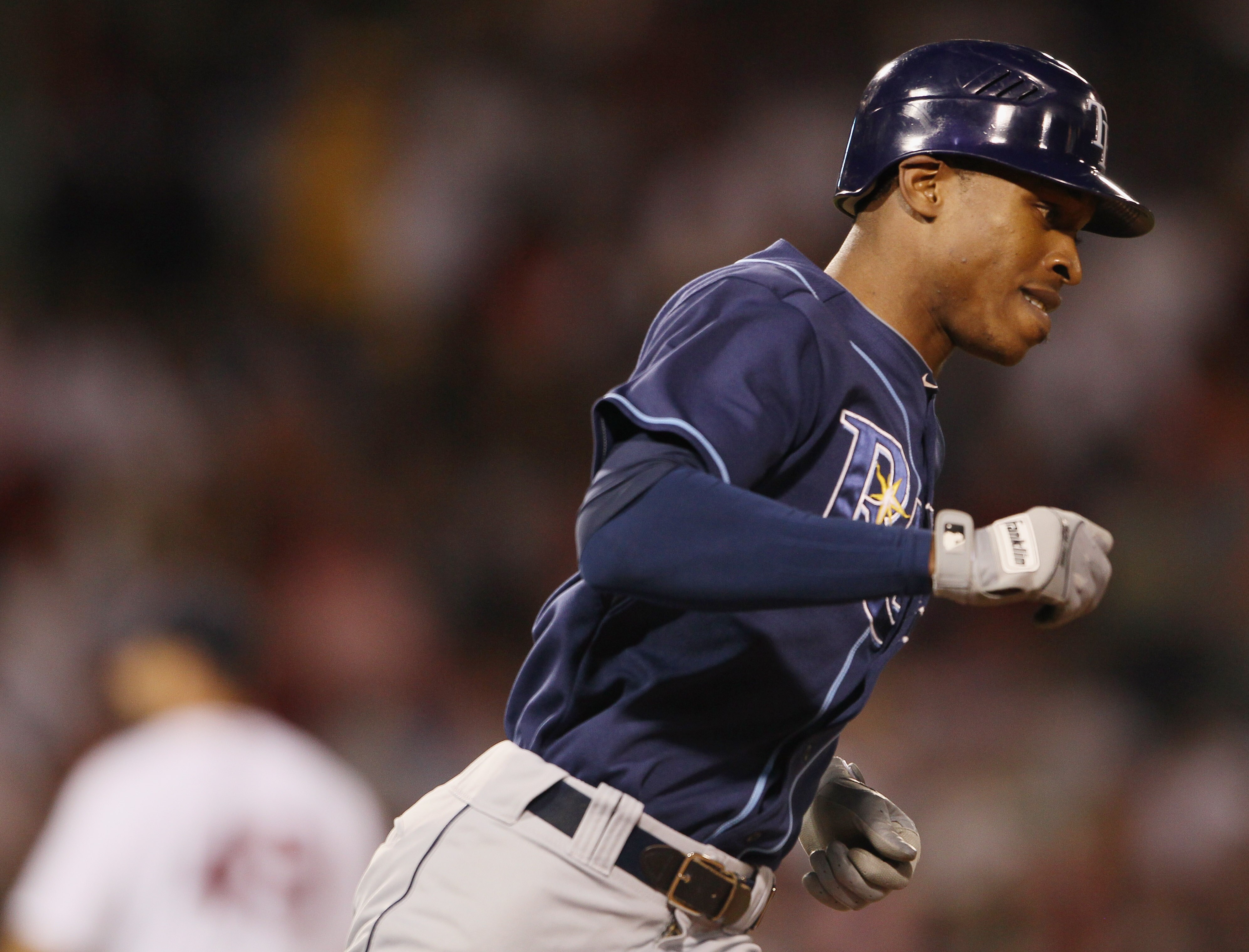 BOSTON - SEPTEMBER 08:  B.J. Upton #2 of the Tampa Bay Rays rounds first base after he hit a three run homer in the second inning as Tim Wakefield #49 of the Boston Red Sox stands by on September 8, 2010 at Fenway Park in Boston, Massachusetts.  (Photo by