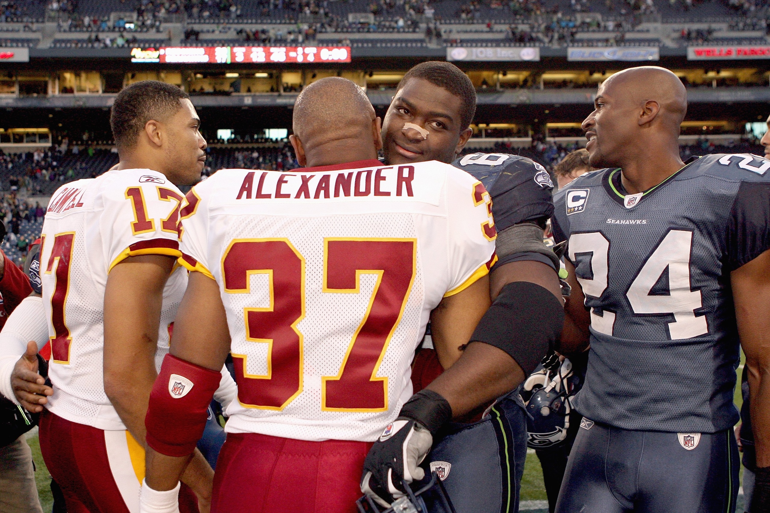 SEATTLE - NOVEMBER 23:  Shaun Alexander #37 of the Washington Redskins hugs old teammate Chris Spencer #65 of the Seattle Seahawks on November 23, 2008 at Qwest Field in Seattle, Washington. (Photo by Otto Greule Jr/Getty Images)