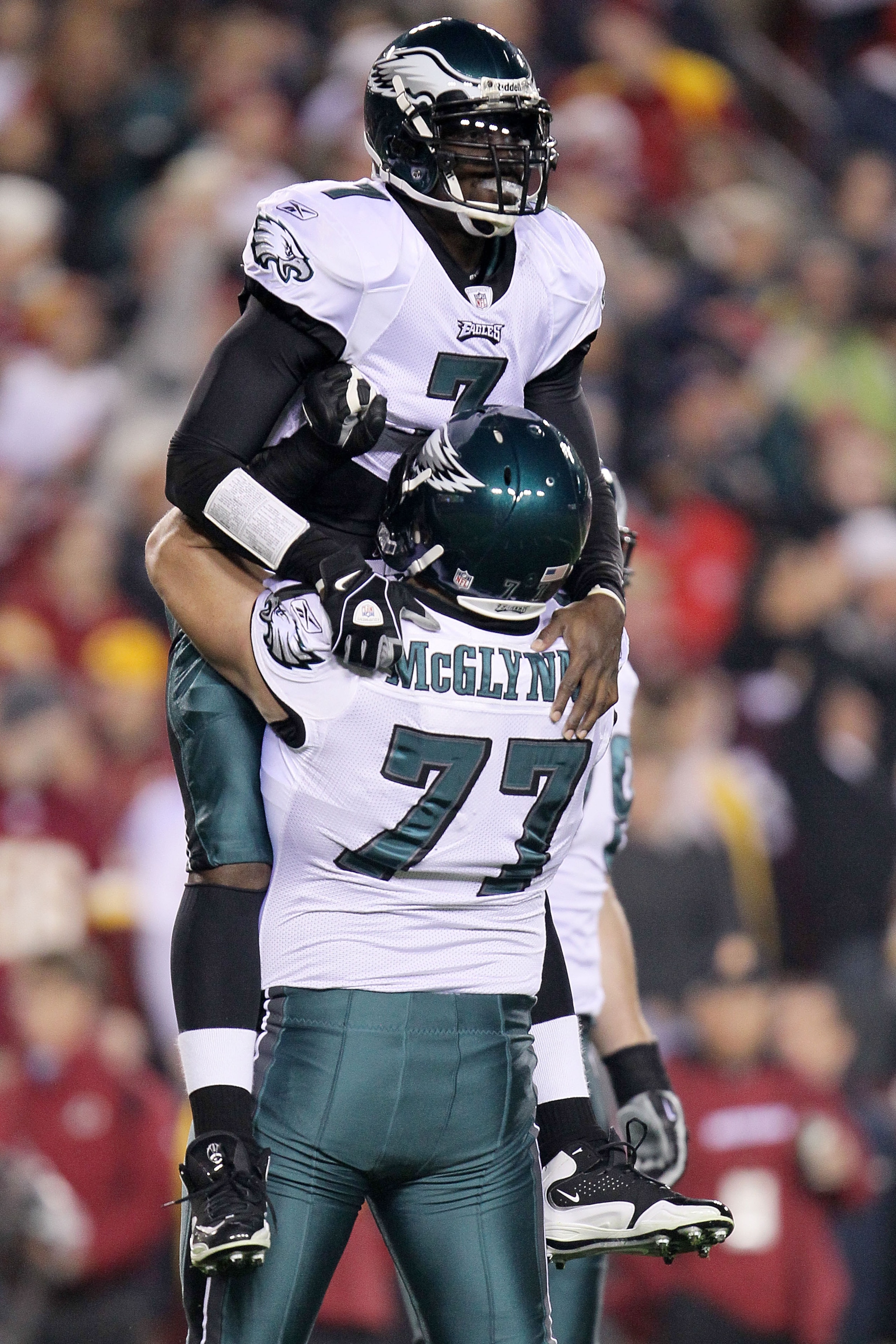 LANDOVER, MD - NOVEMBER 15:  Michael Vick #7 of the Philadelphia Eagles celebrates with team mate Mike McGlynn #77 after throwing his teams first touchdown against the Washington Redskins on November 15, 2010 at FedExField in Landover, Maryland.  (Photo b