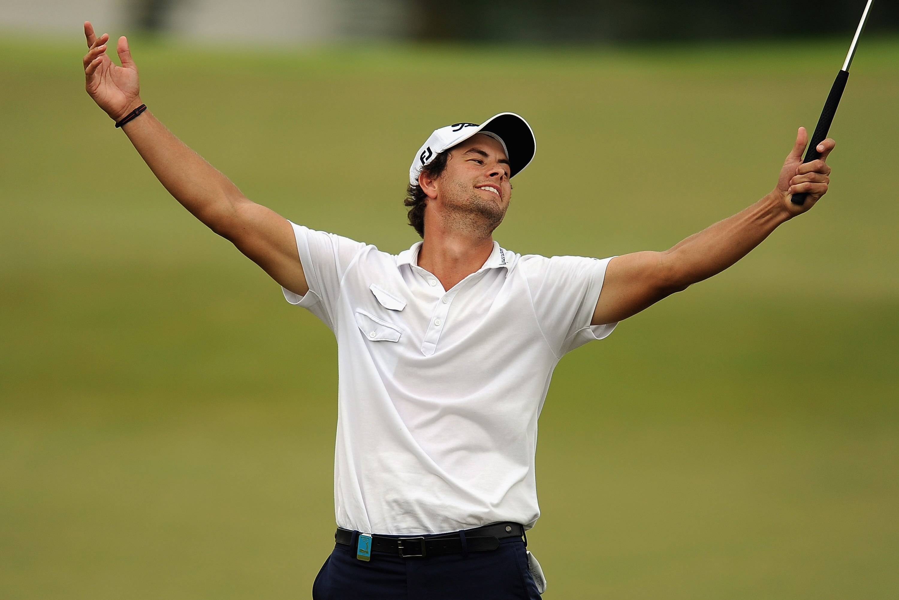 SINGAPORE - NOVEMBER 15: Adam Scott of Australia celebrates on sinking a birdie on the 18th hole to win the Barclays Singapore Open on a 17 uner par 267 during the Final Round of the Barclays Singapore Open held at the Sentosa Golf Club on November 15, 20