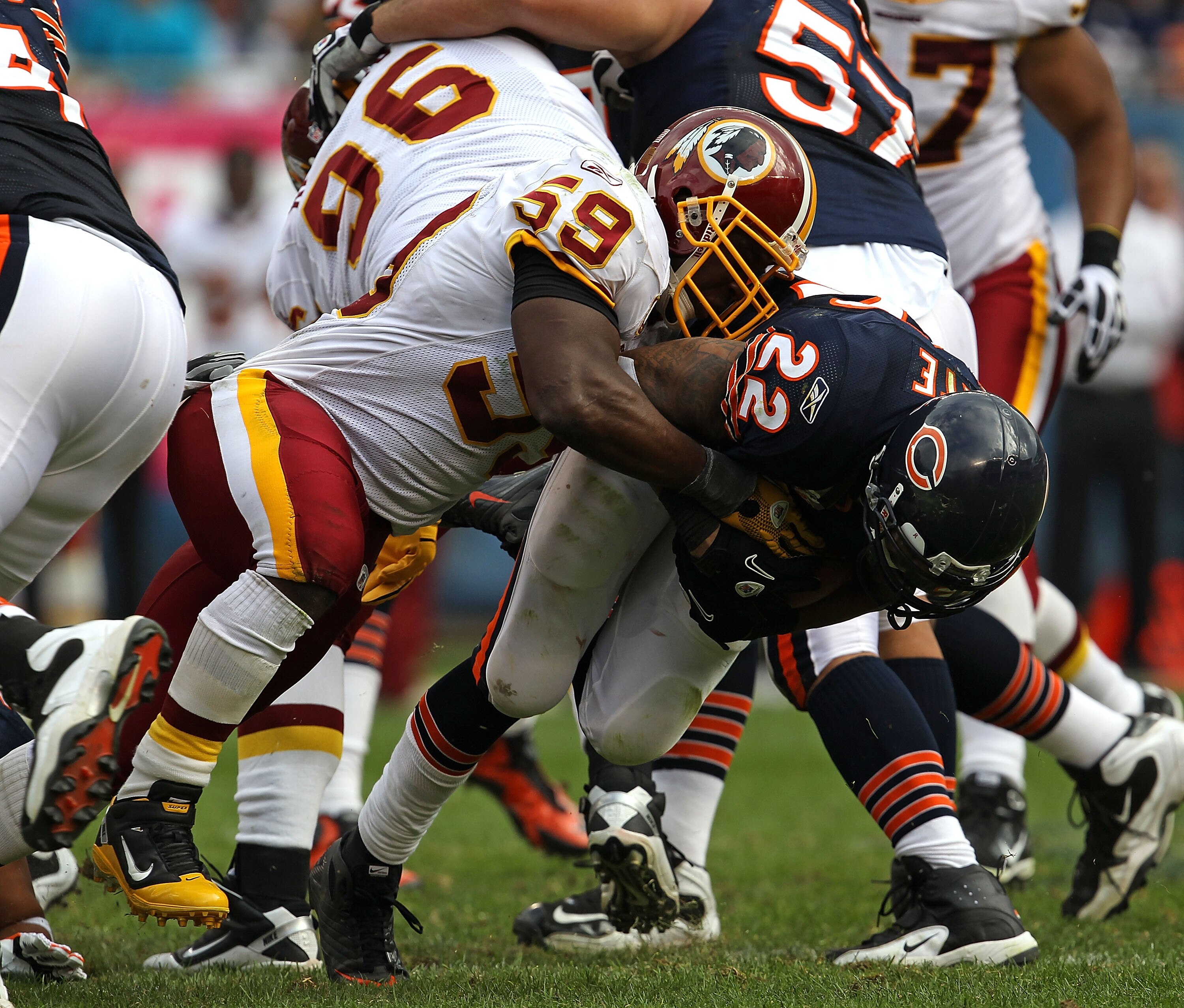 CHICAGO - OCTOBER 24: Matt Forte #22 of the Chicago Bears is dropped by London Fletcher #59 of the Washington Redskins at Soldier Field on October 24, 2010 in Chicago, Illinois. The Redskins defeated the Bears 17-14. (Photo by Jonathan Daniel/Getty Images