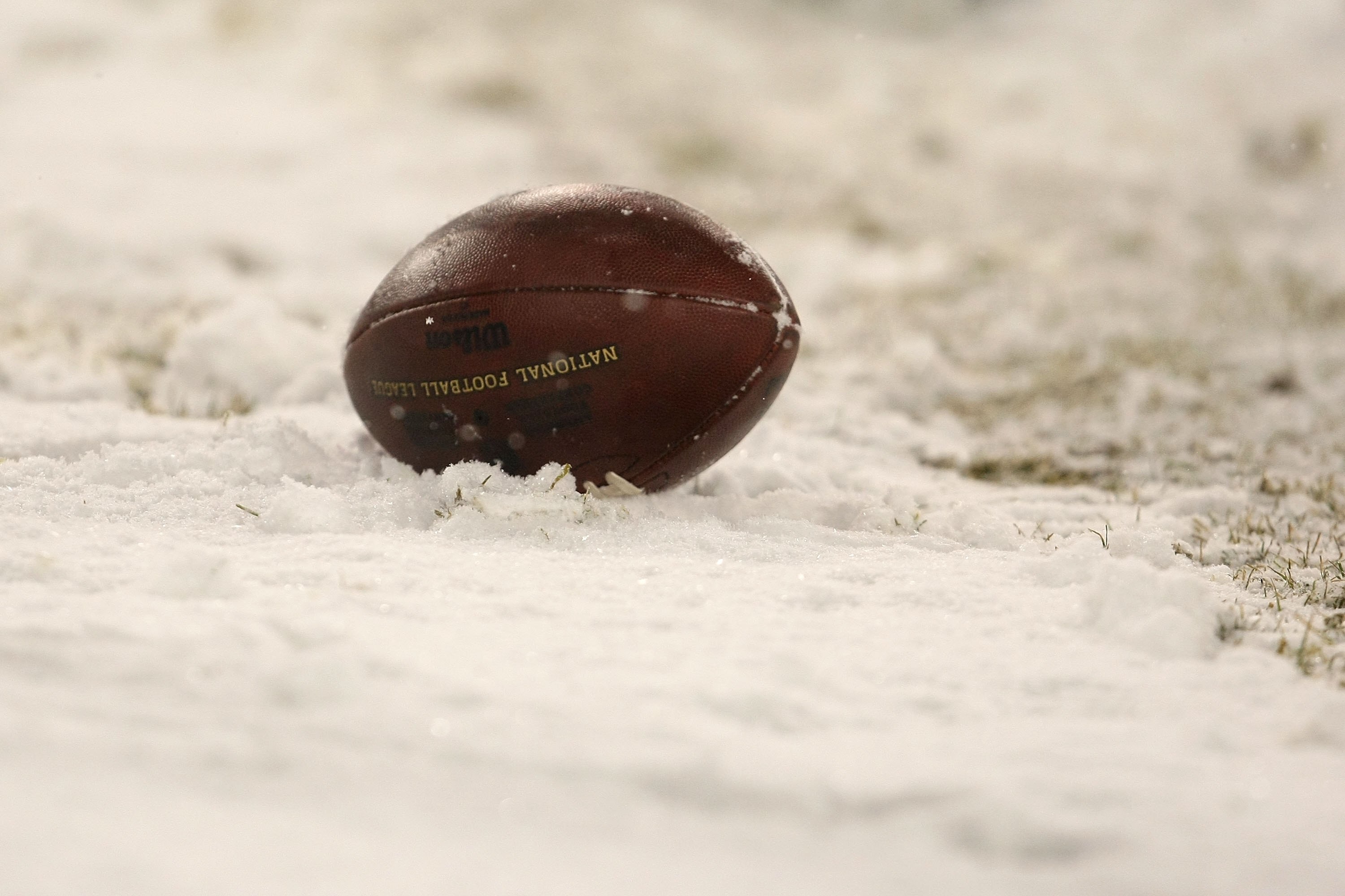 GREEN BAY, WI - JANUARY 12:  A football sits in the snow during the game between the Green Bay Packers and the Seattle Seahawks during the NFC divisional playoff game on January 12, 2008 at Lambeau Field in Green Bay, Wisconsin.  (Photo by Jonathan Daniel