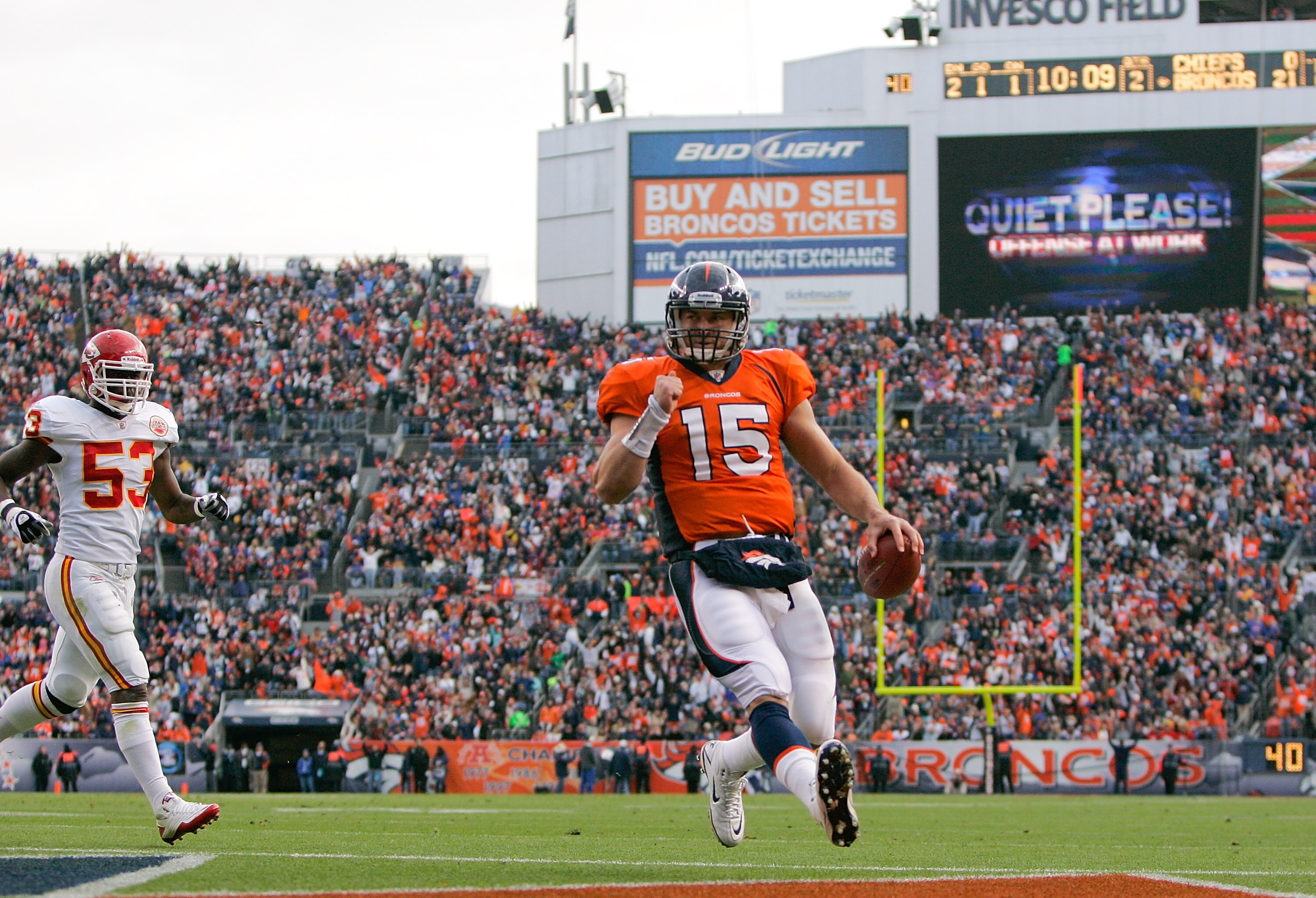 DENVER - NOVEMBER 14:  Quarterback Tim Tebow #15 of the Denver Broncos scores on a 1-yard touchdown run as linebacker Demorrio Williams #53 of the Kansas City Chiefs gives chase during the second quarter at INVESCO Field at Mile High on November 14, 2010 