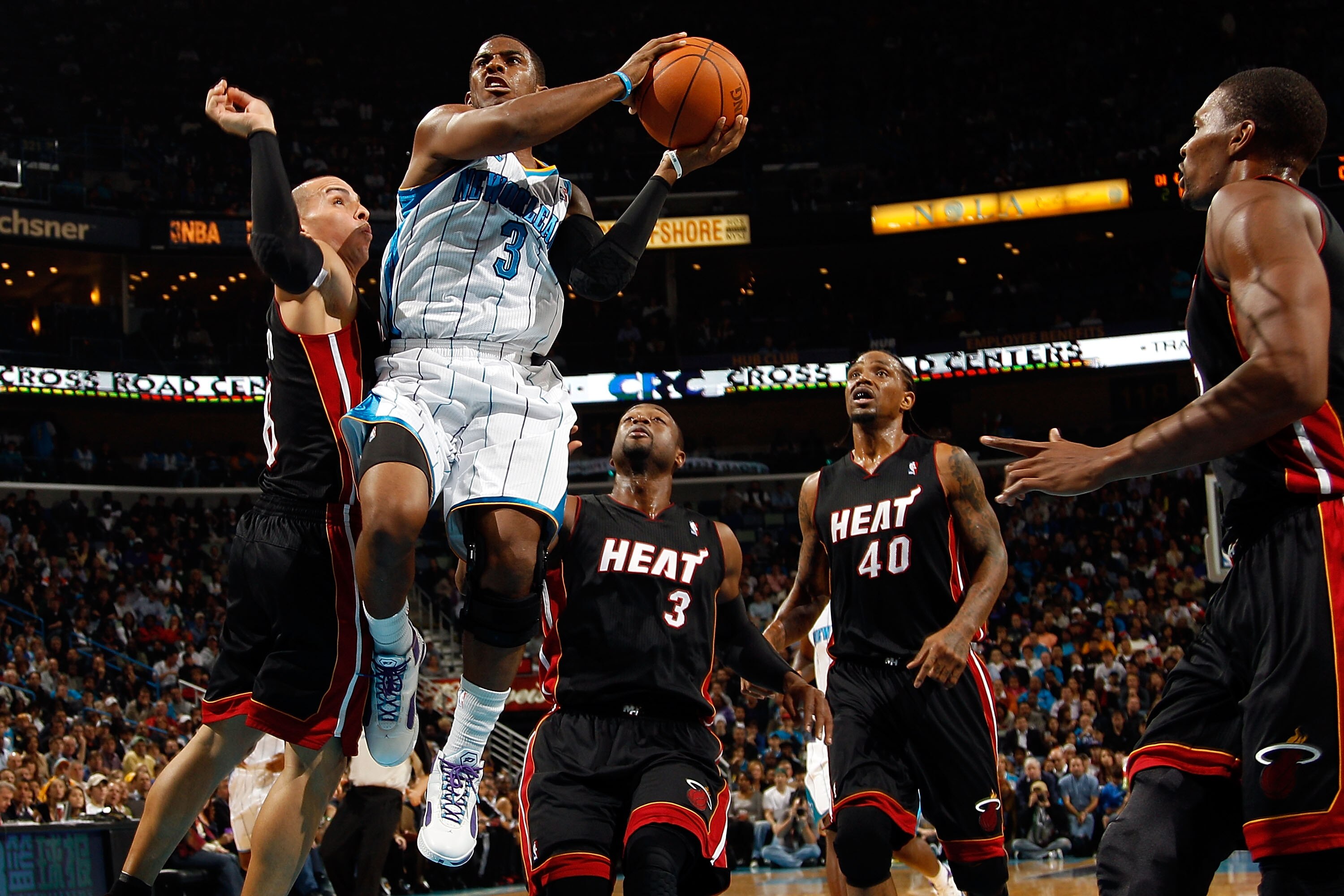 NEW ORLEANS - NOVEMBER 05:  Chris Paul #3 of the New Orleans Hornets shoots the ball over Carlos Arroyo #8 of the Miami Heat at the New Orleans Arena on November 5, 2010 in New Orleans, Louisiana.  NOTE TO USER: User expressly acknowledges and agrees that