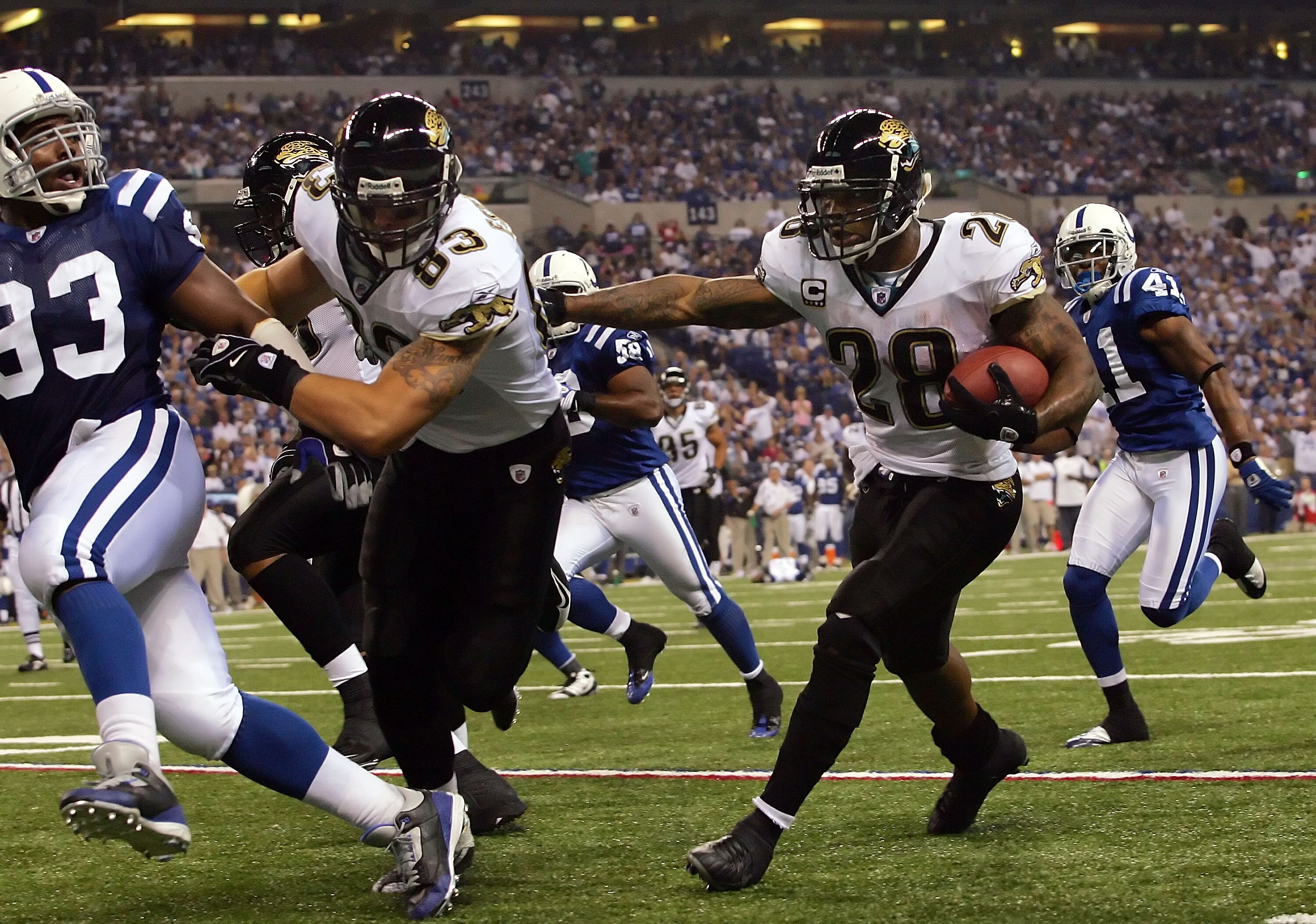 INDIANAPOLIS - SEPTEMBER 21:  Running back Fred Taylor #28 of the Jacksonville Jaguars receives a block by Greg Estandia #83 against Dwight Freeney #83  of the Indianapolis Colts on September 21, 2008 at Lucas Oil Stadium in Indianapolis, Indiana.  (Photo