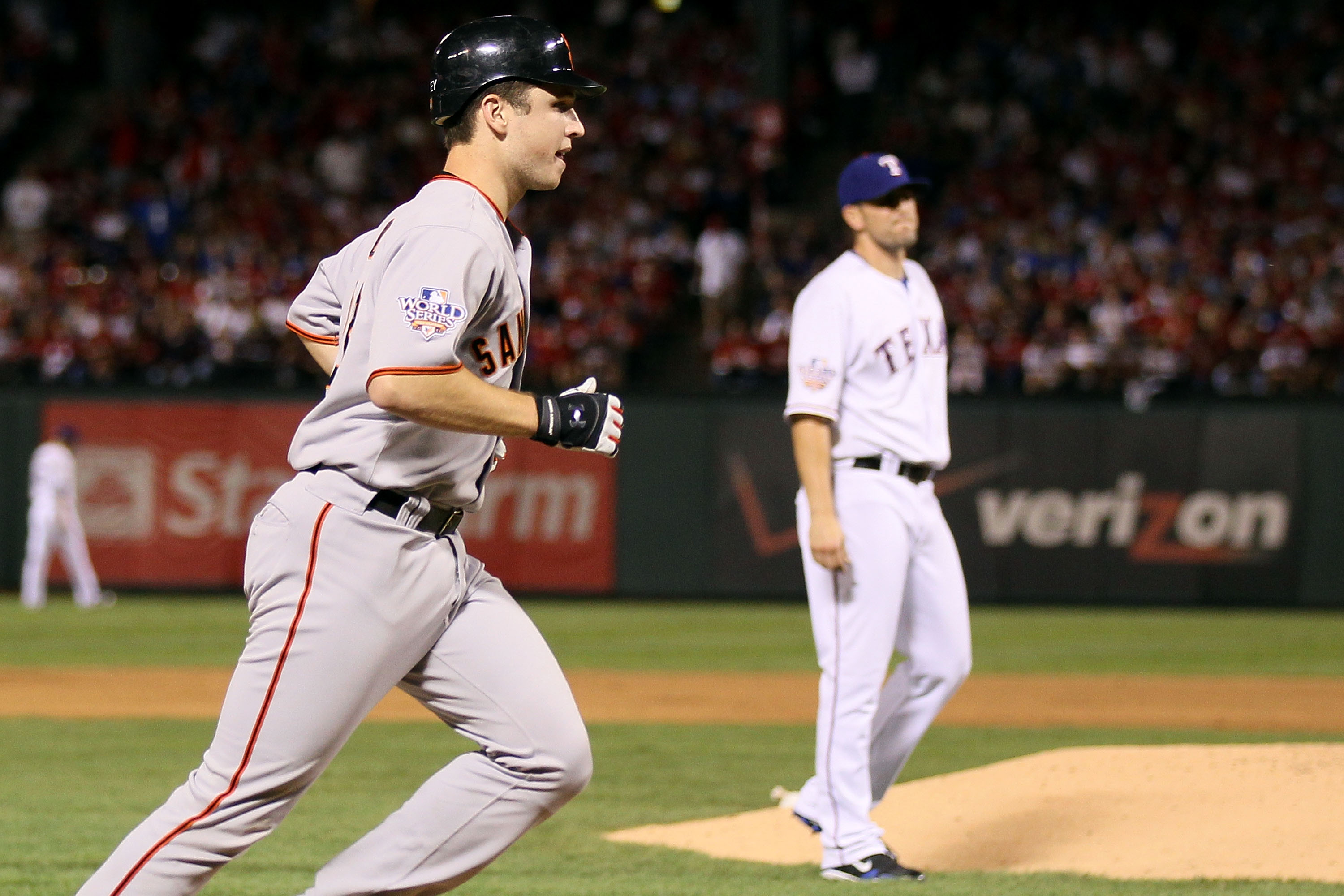 ARLINGTON, TX - OCTOBER 31:  Buster Posey #28 of the San Francisco Giants runs towards home plate to score on his solo home run in the eighthinning against Darren O'Day #56 of the Texas Rangers in Game Four of the 2010 MLB World Series at Rangers Ballpark