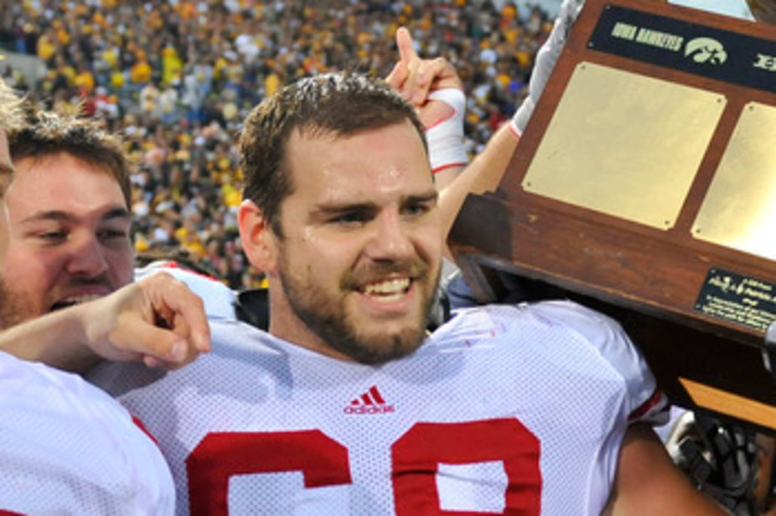 IOWA CITY, IA - OCTOBER 23: Offensive lineman Gabe Carimi #68 for the Wisconsin Badger holds the Heartland Trophy with his teammates as they celebrate their victory of the University of Iowa Hawkeyes at Kinnick Stadium on October 23, 2010 in Iowa City, Io
