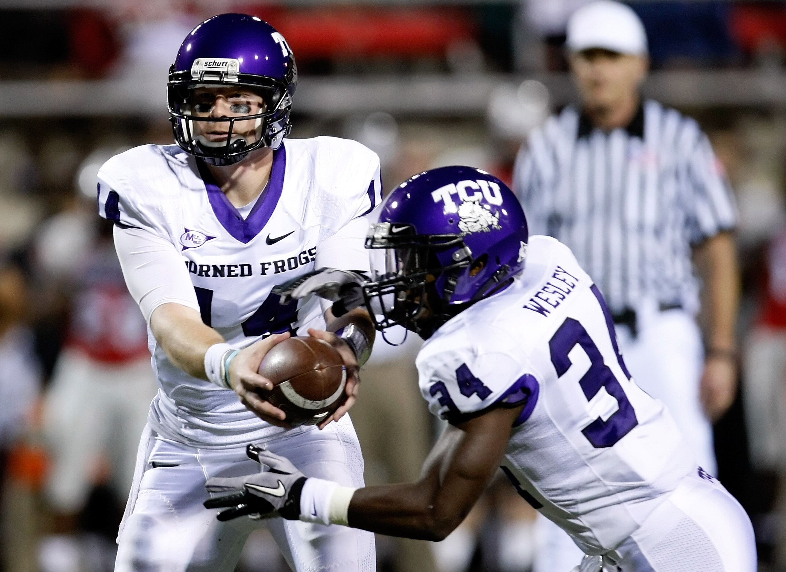 LAS VEGAS - OCTOBER 30: Quarterback Andy Dalton #14 of the Texas Christian University Horned Frogs hands the ball off to Ed Wesley #34 during their game against the UNLV Rebels at Sam Boyd Stadium October 30, 2010 in Las Vegas, Nevada. TCU won 48-6. (Ph LAS VEGAS - OCTOBER 30: Quarterback Andy Dalton #14 of the Texas Christian University Horned Frogs hands the ball off to Ed Wesley #34 during their game against the UNLV Rebels at Sam Boyd Stadium October 30, 2010 in Las Vegas, Nevada. TCU won 48-6. (Ph