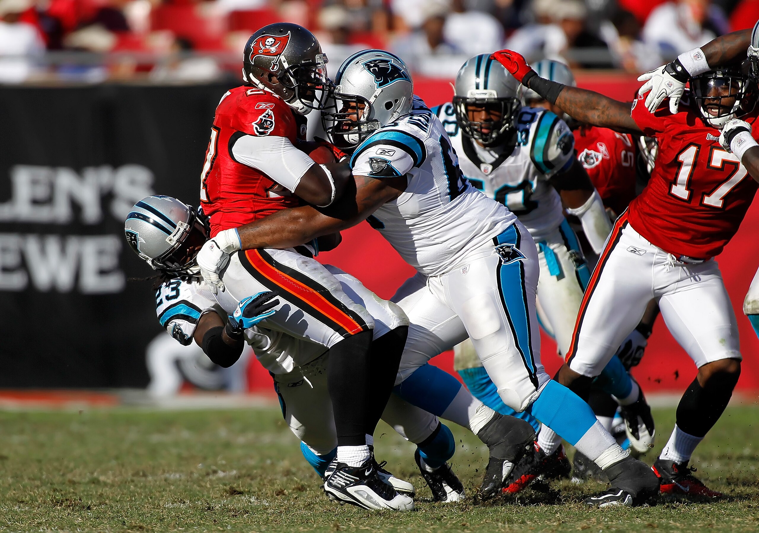 TAMPA, FL - NOVEMBER 14:  Defenders Andre Neblett #68 and Sherrod Martin #23 of the Carolina Panthers tackle running back LeGarrette Blount #27 of the Tampa Bay Buccaneers during the game at Raymond James Stadium on November 14, 2010 in Tampa, Florida.  (
