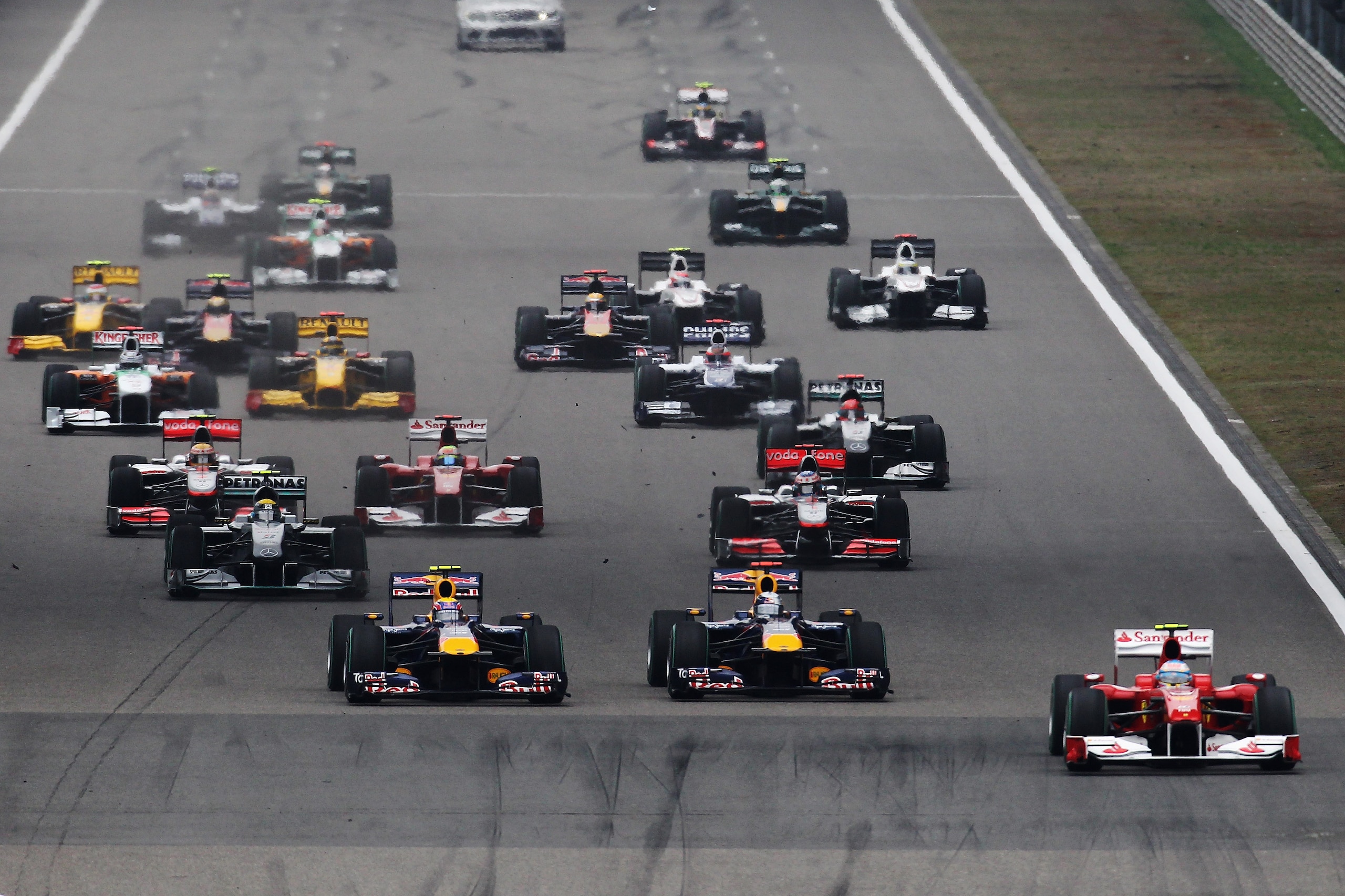 SHANGHAI, CHINA - APRIL 18:  Fernando Alonso (R) of Spain and Ferrari gets a good start to the first corner during the Chinese Formula One Grand Prix at the Shanghai International Circuit on April 18, 2010 in Shanghai, China.  (Photo by Paul Gilham/Getty