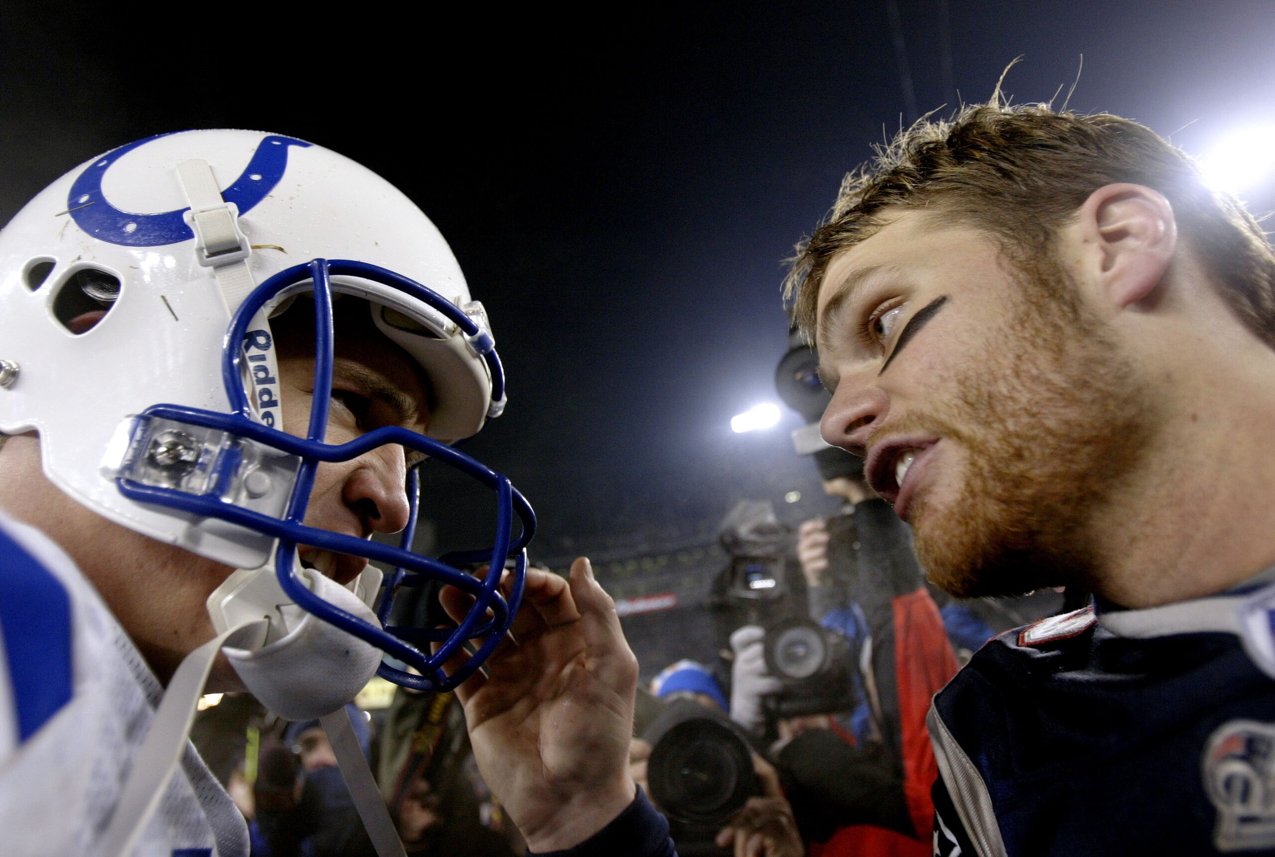 FOXBORO, MA - JANUARY 18:  Quarterback Tom Brady #12 of the New England Patriots and quarterback Peyton Manning #18 of the Indianapolis Colts greet each other on the field after the AFC Championship Game on January 18, 2004 at Gillette Stadium in Foxboro,
