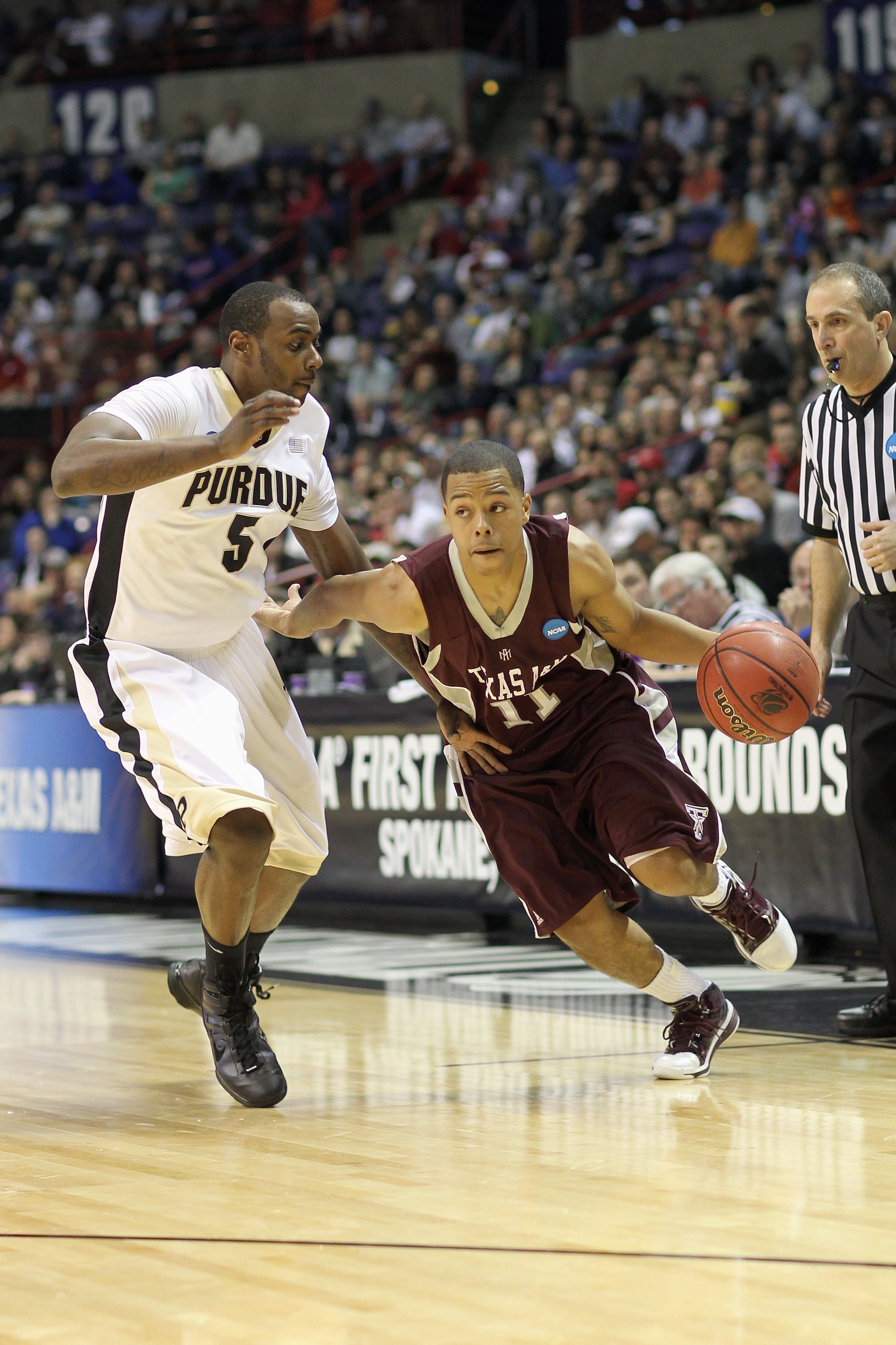 SPOKANE, WA - MARCH 21: B.J. Holmes #11 of the Texas A&M Aggies drives the ball against Keaton Grant #5 of the Purdue Boilermakers during the second round of the 2010 NCAA men's basketball tournament at the Spokane Arena on March 21, 2010 in Spokane, Wash