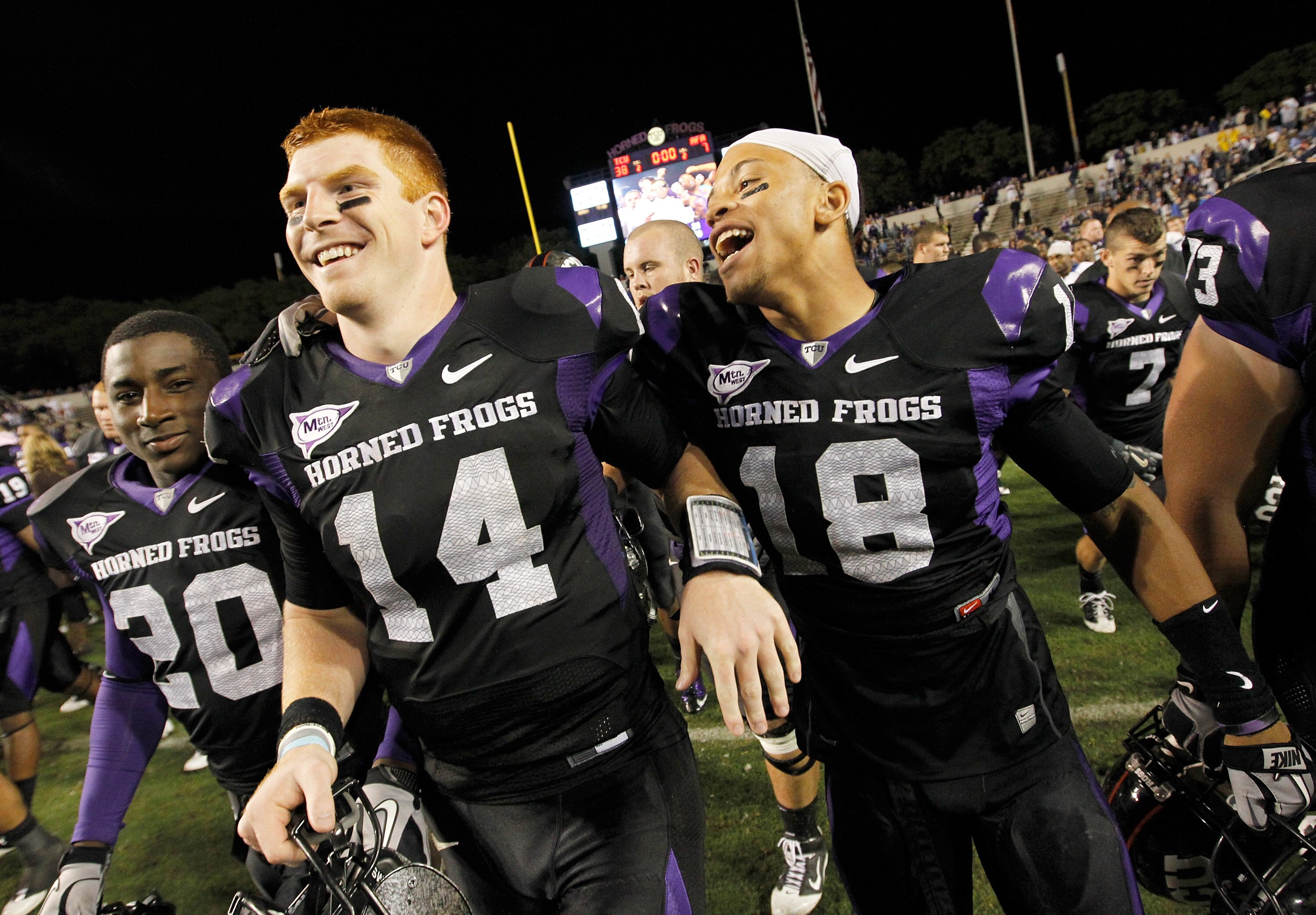 FORT WORTH, TX - OCTOBER 23:  Quarterback Andy Dalton #14 of the TCU Horned Frogs celebrates with cornerback Travaras Battle #18 after TCU beat the Air Force Falcons 38-7 at Amon G. Carter Stadium on October 23, 2010 in Fort Worth, Texas.  (Photo by Tom P