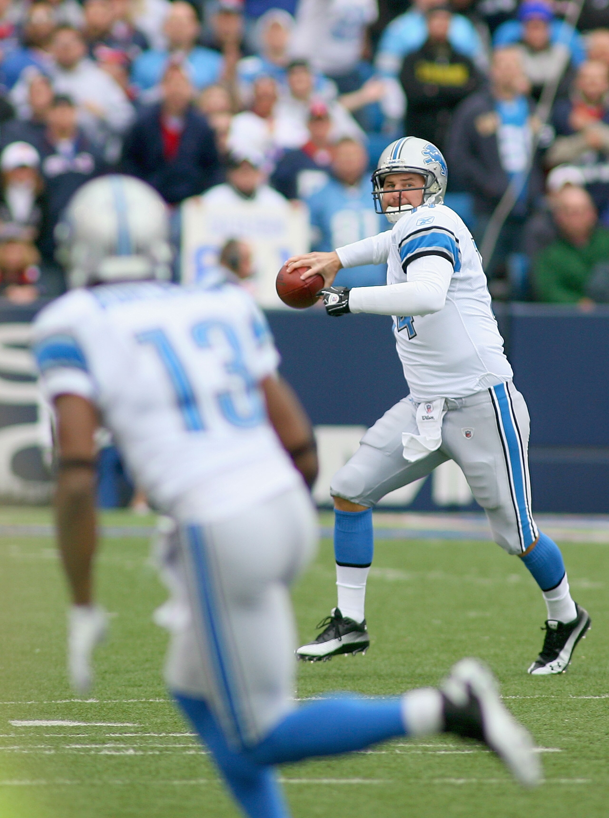 ORCHARD PARK, NY - NOVEMBER 14:  Shaun Hill #14 of the Detroit Lions readies to throw a pass to Nate Burleson #13 against the Buffalo Bills  at Ralph Wilson Stadium on November 14, 2010 in Orchard Park, New York.  (Photo by Rick Stewart/Getty Images)