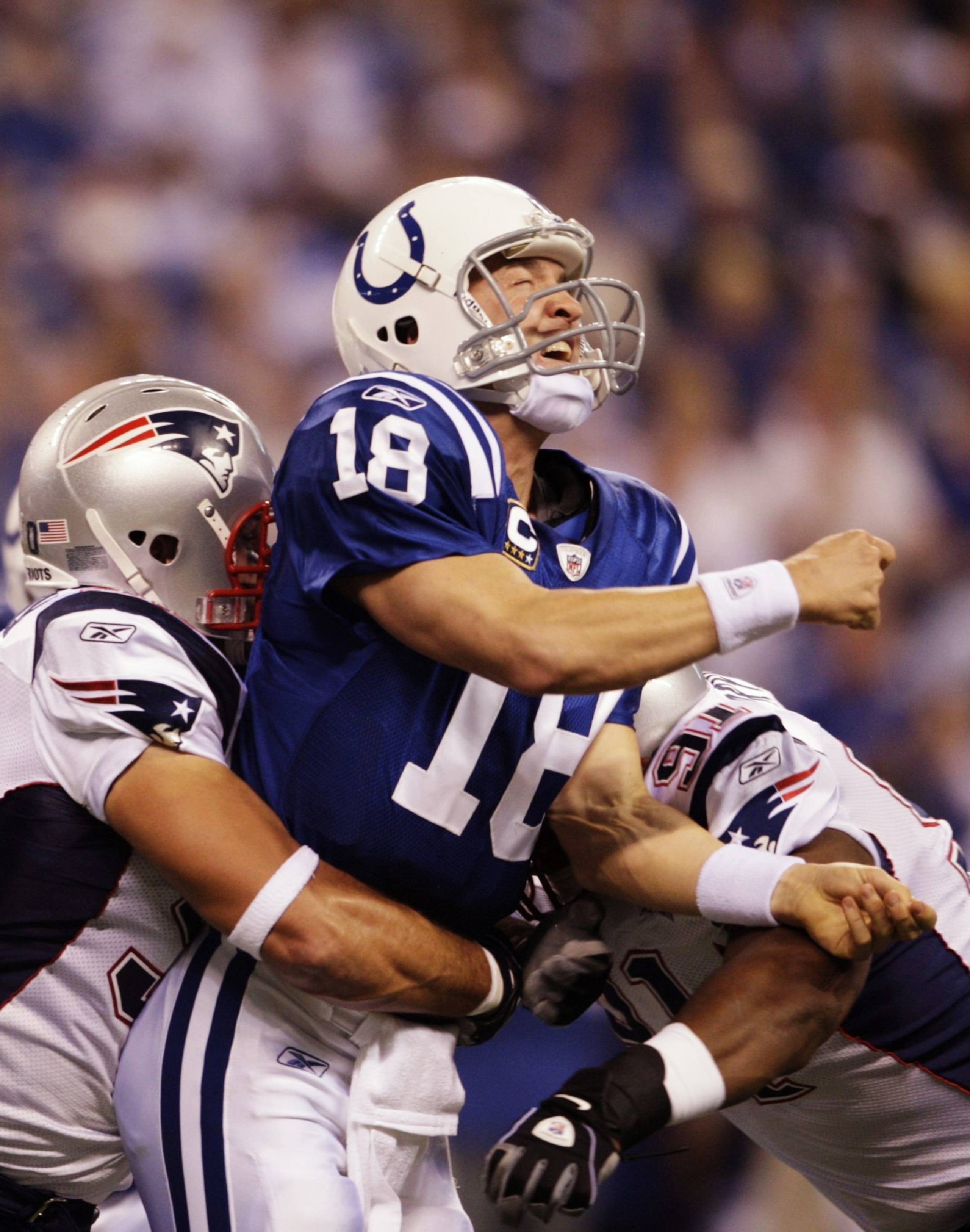 INDIANAPOLIS - NOVEMBER 15:  Quarterback Peyton Manning #18 of the Indianapolis Colts throws a pass before being stopped by Rob Ninkovich #50 of the New England Patriots during the first quarter of the game at Lucas Oil Stadium on November 15, 2009 in Ind
