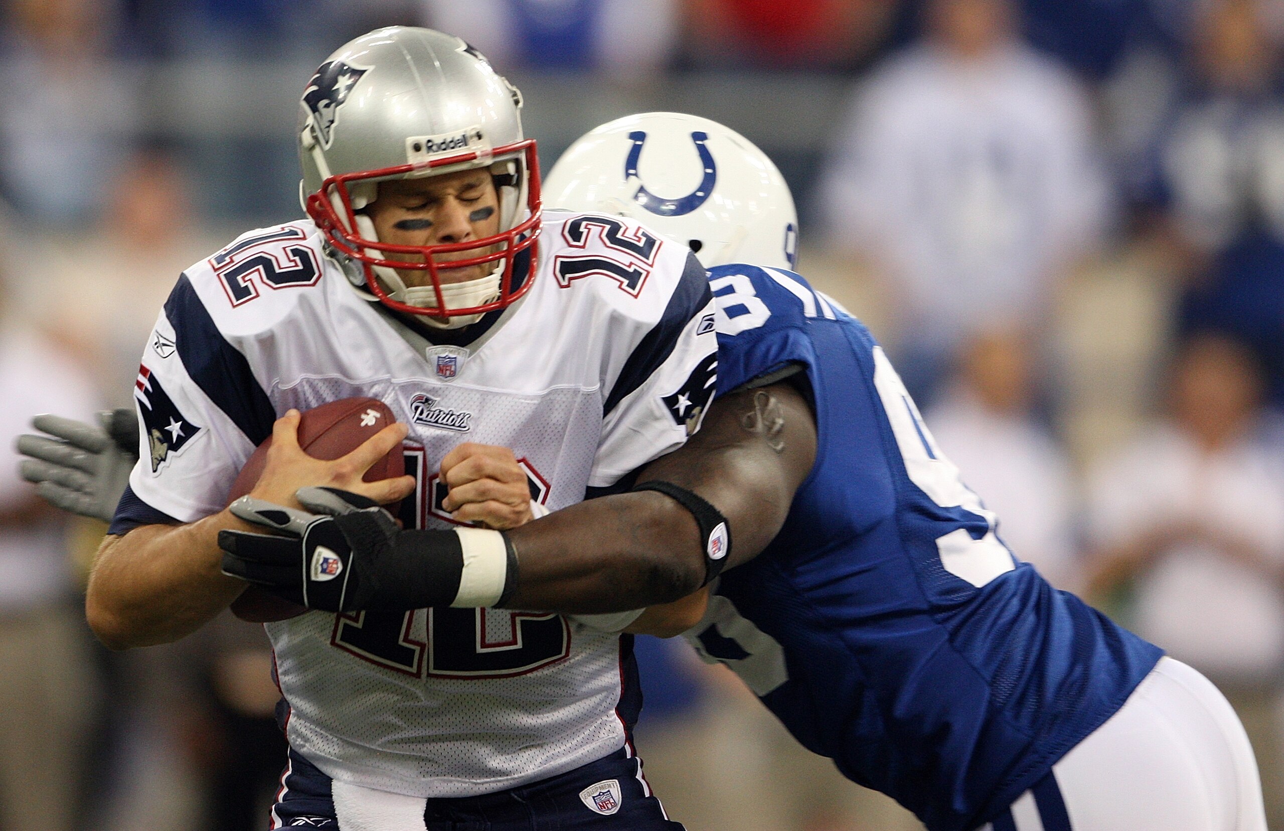 INDIANAPOLIS - NOVEMBER 04:  Tom Brady #12 of the New England Patriots is sacked by Robert Mathis #98 of the Indianapolis Colts on November 4, 2007 at the RCA Dome in Indianapolis, Indiana.  (Photo by Andy Lyons/Getty Images)