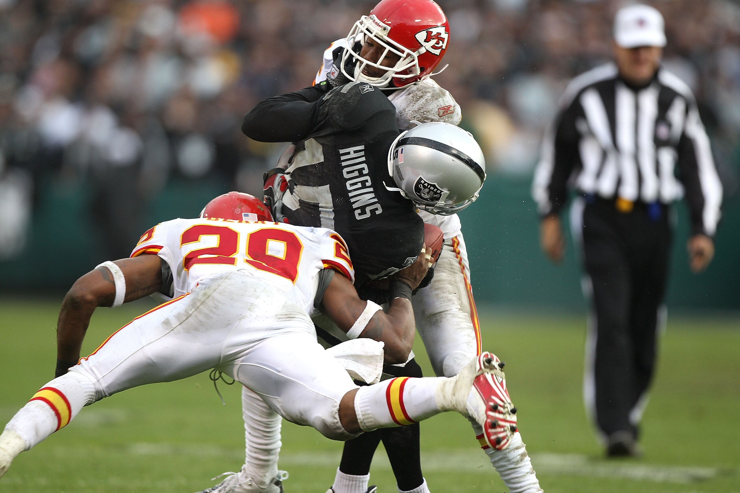 OAKLAND, CA - NOVEMBER 07:  Johnnie Lee Higgins #15 of the Oakland Raiders is tackled after a catch by Brandon Flowers #24 and Eric Berry #29 of the Kansas City Chiefs during an NFL game at Oakland-Alameda County Coliseum on November 7, 2010 in Oakland, C
