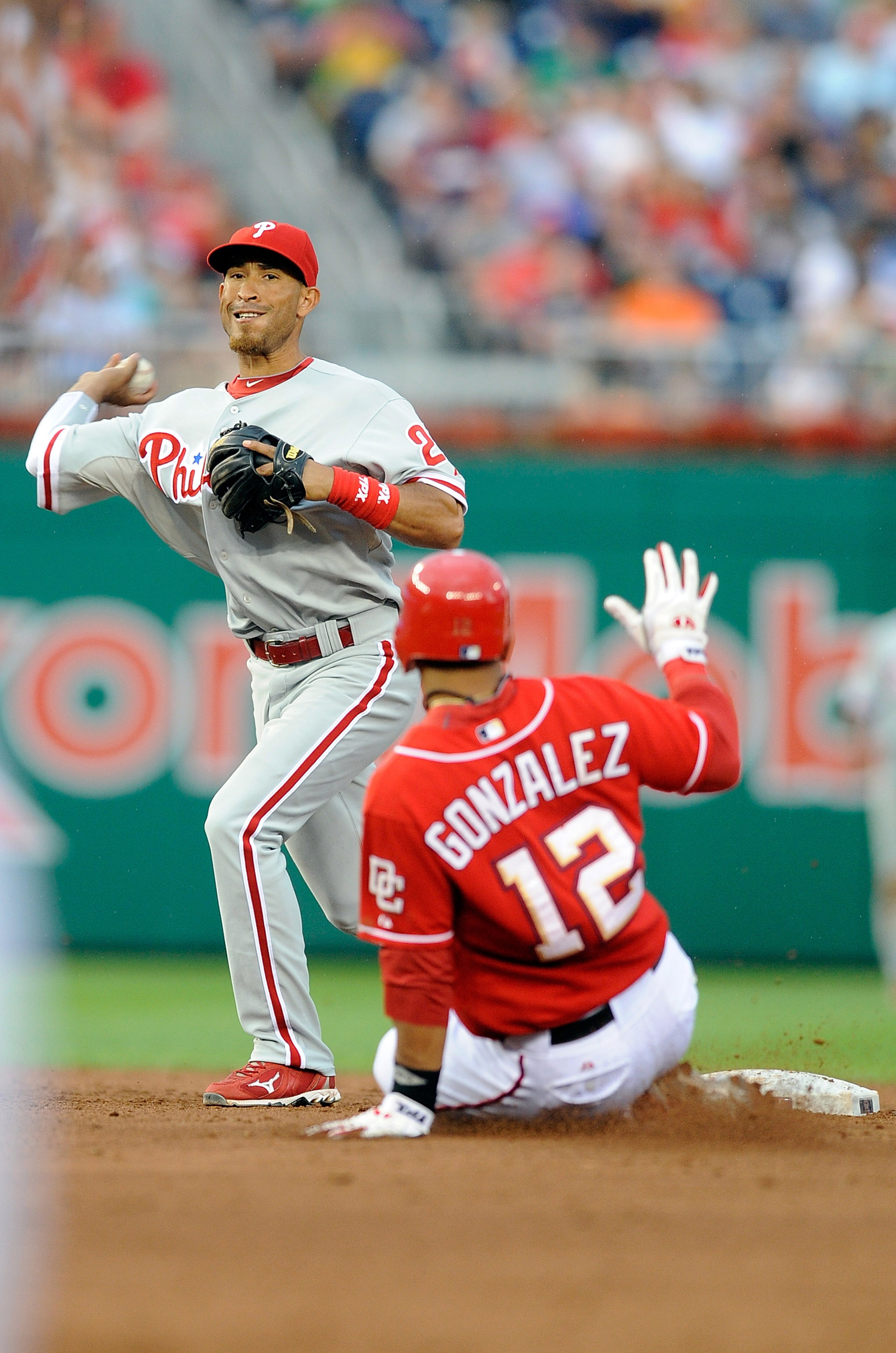 WASHINGTON - AUGUST 01:  Wilson Valdez #21 of the Philadelphia Phillies forces out Alberto Gonzalez #12 of the Washington Nationals to start a double play at Nationals Park on August 1, 2010 in Washington, DC. The Phillies won the game 6-4.  (Photo by Gre