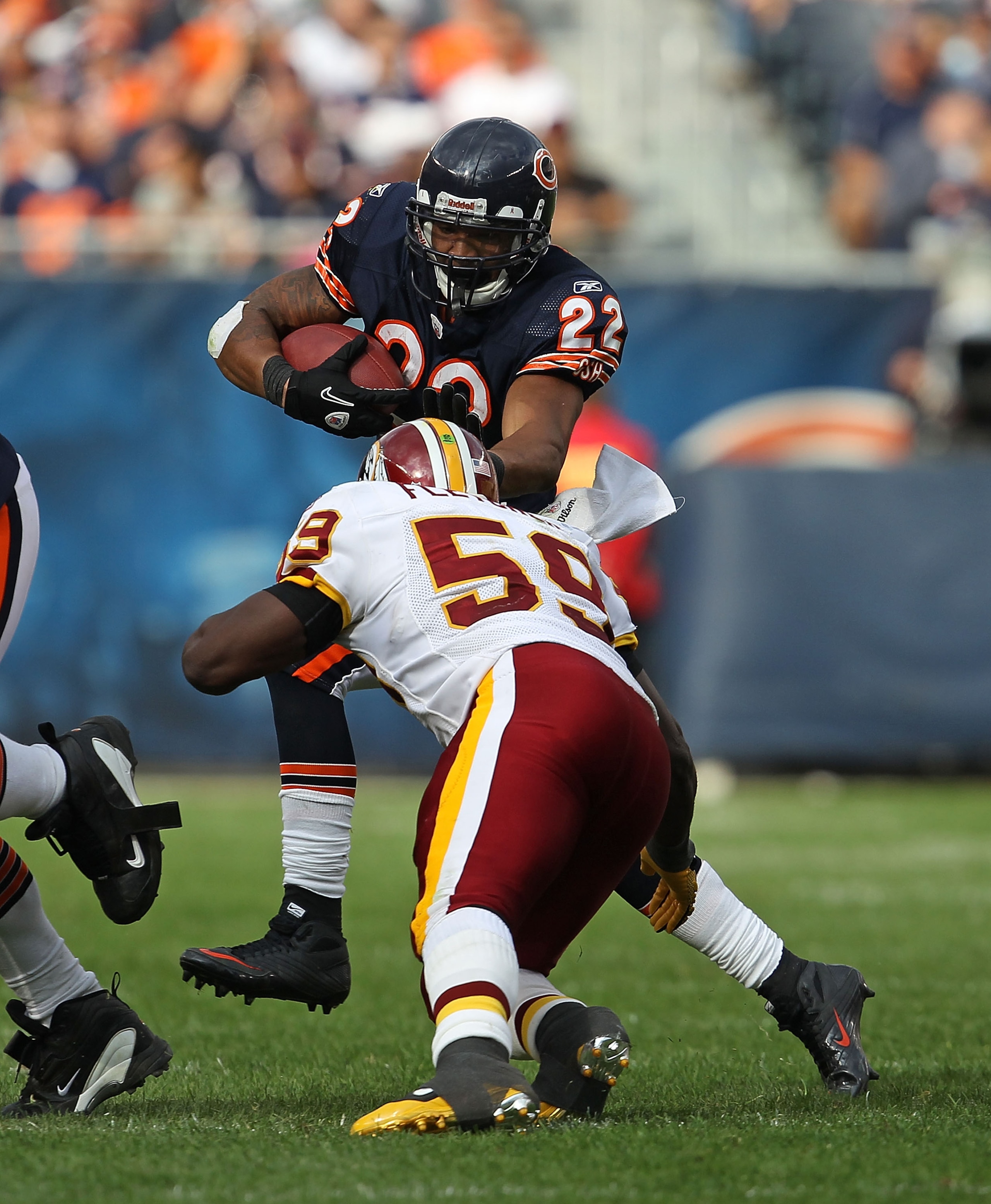 CHICAGO - OCTOBER 24: Matt Forte #22 of the Chicago Bears avoids a tackle attempt by London Fletcher #59 of the Washington Redskins at Soldier Field on October 24, 2010 in Chicago, Illinois. The Redskins defeated the Bears 17-14. (Photo by Jonathan Daniel