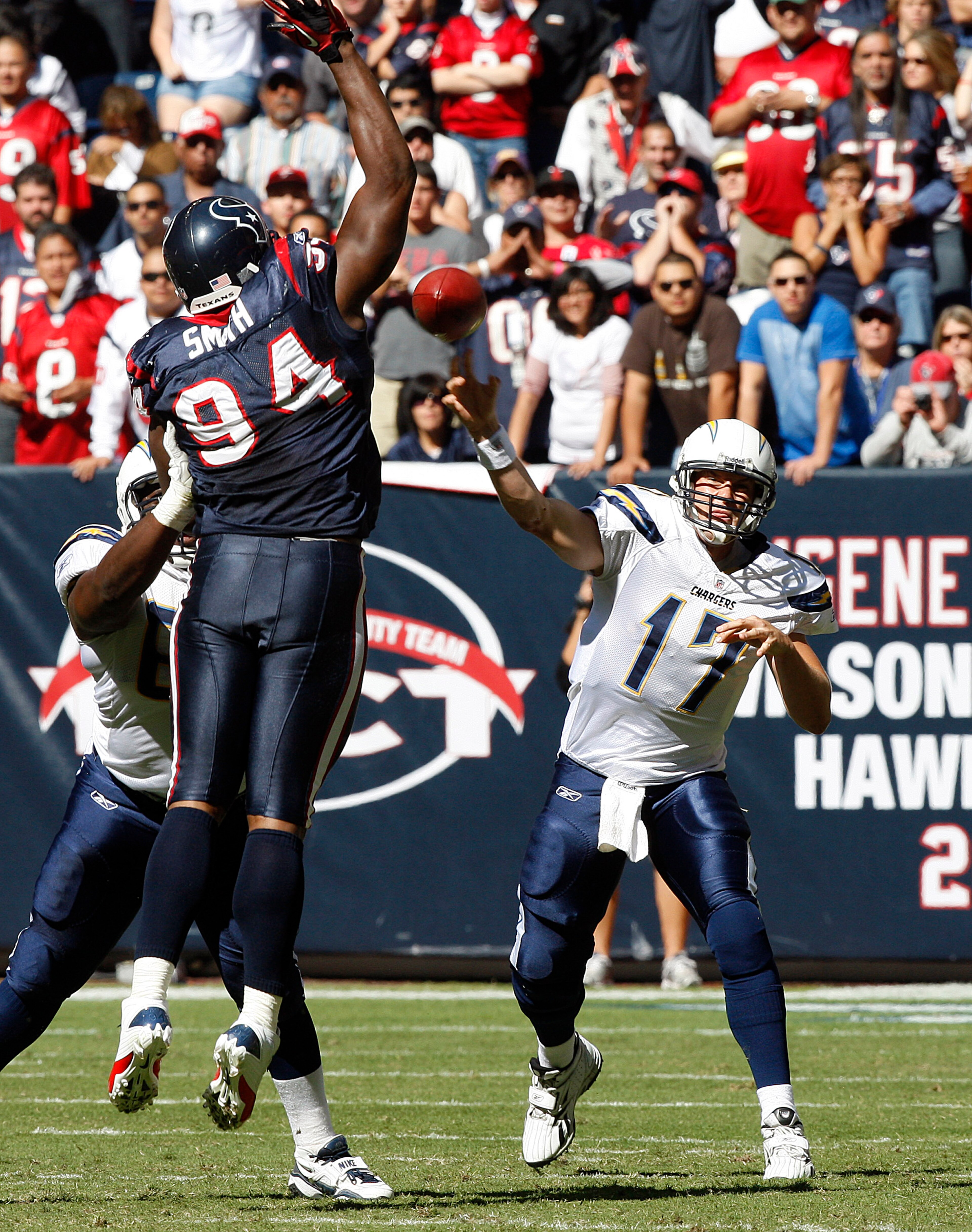 HOUSTON - NOVEMBER 07:  Quarterback Philip Rivers #17 of the San Diego Chargers throws over defensive end Antonio Smith #94 of the Houston Texans at Reliant Stadium on November 7, 2010 in Houston, Texas.  (Photo by Bob Levey/Getty Images)