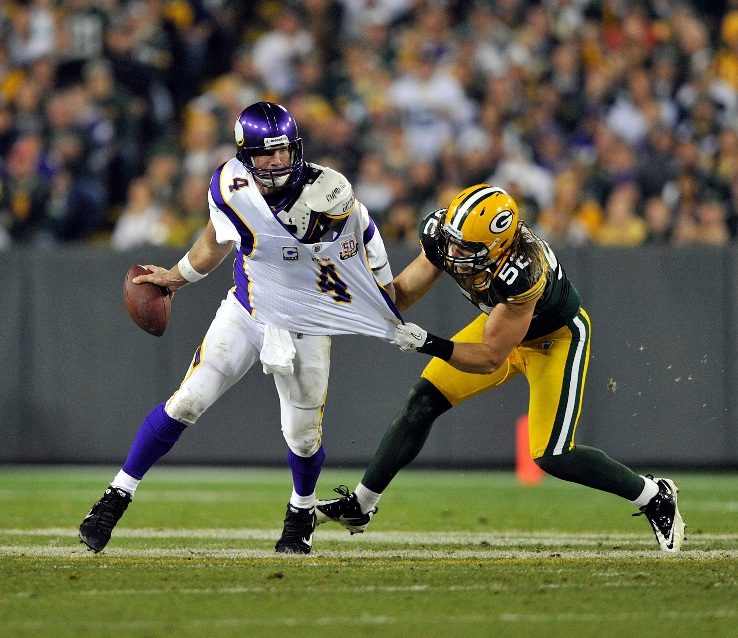 GREEN BAY, WI - OCTOBER 24:  Brett Favre #4 of the Minnesota Vikings has his jersey grabbed by Clay Matthews #52 of the Green Bay Packers at Lambeau Field on October 24, 2010 in Green Bay, Wisconsin. (Photo by Jim Prisching/Getty Images)