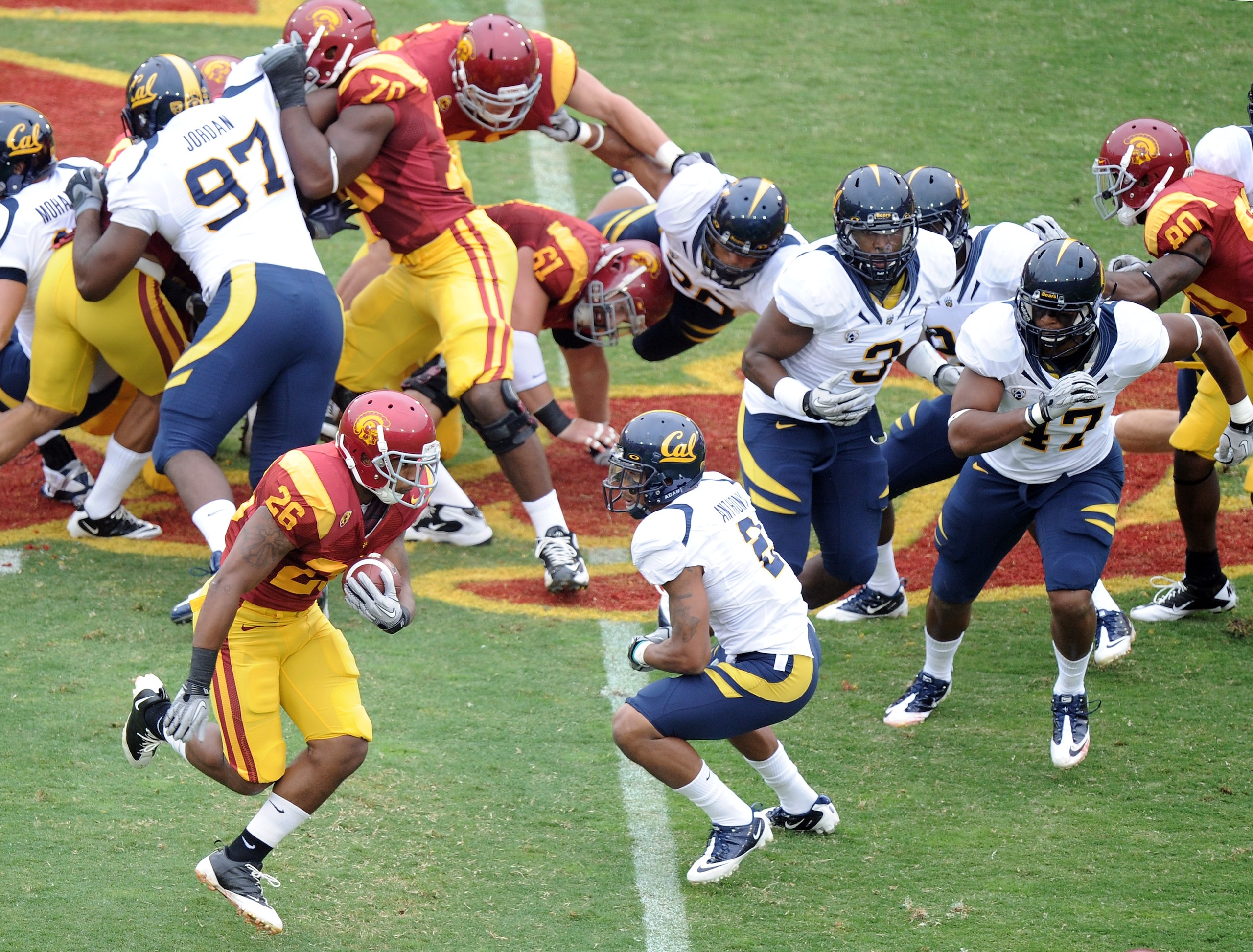 LOS ANGELES, CA - OCTOBER 16:  Marc Tyler #26 of the USC Trojans rushes by Marc Anthony #2 of the California Golden Bears during the first quarter at Los Angeles Memorial Coliseum on October 16, 2010 in Los Angeles, California.  (Photo by Harry How/Getty 