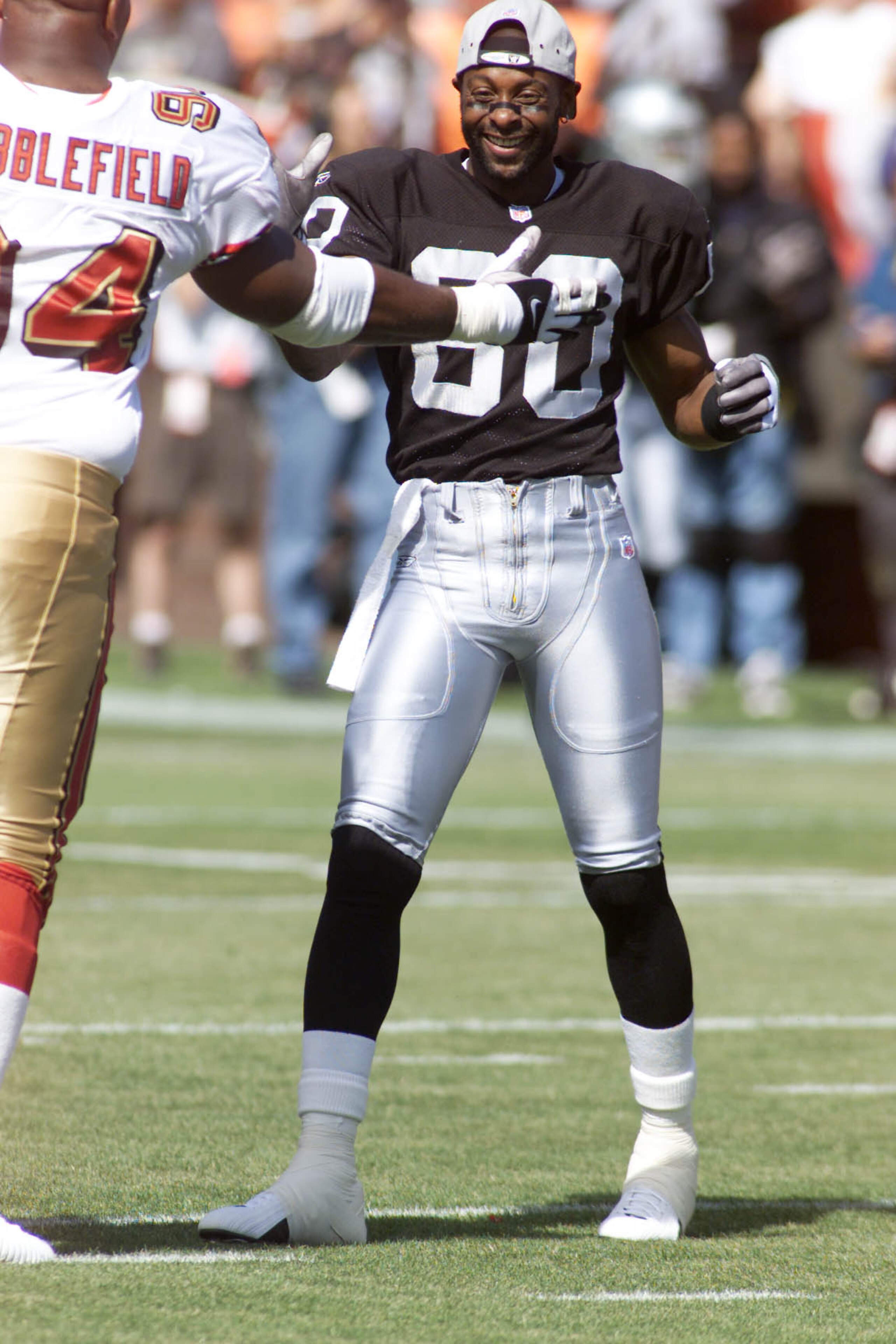 19 Aug 2001: Jerry Rice of the Oakland Raiders greets Dana Stubblefield of the San Francisco 49ers during the pre-season game at 3Comm Park in San Francisco, California. The 49ers defeated the Raiders 20-17. DIGITAL IMAGE. Mandatory Credit: Jed Jacobsohn/