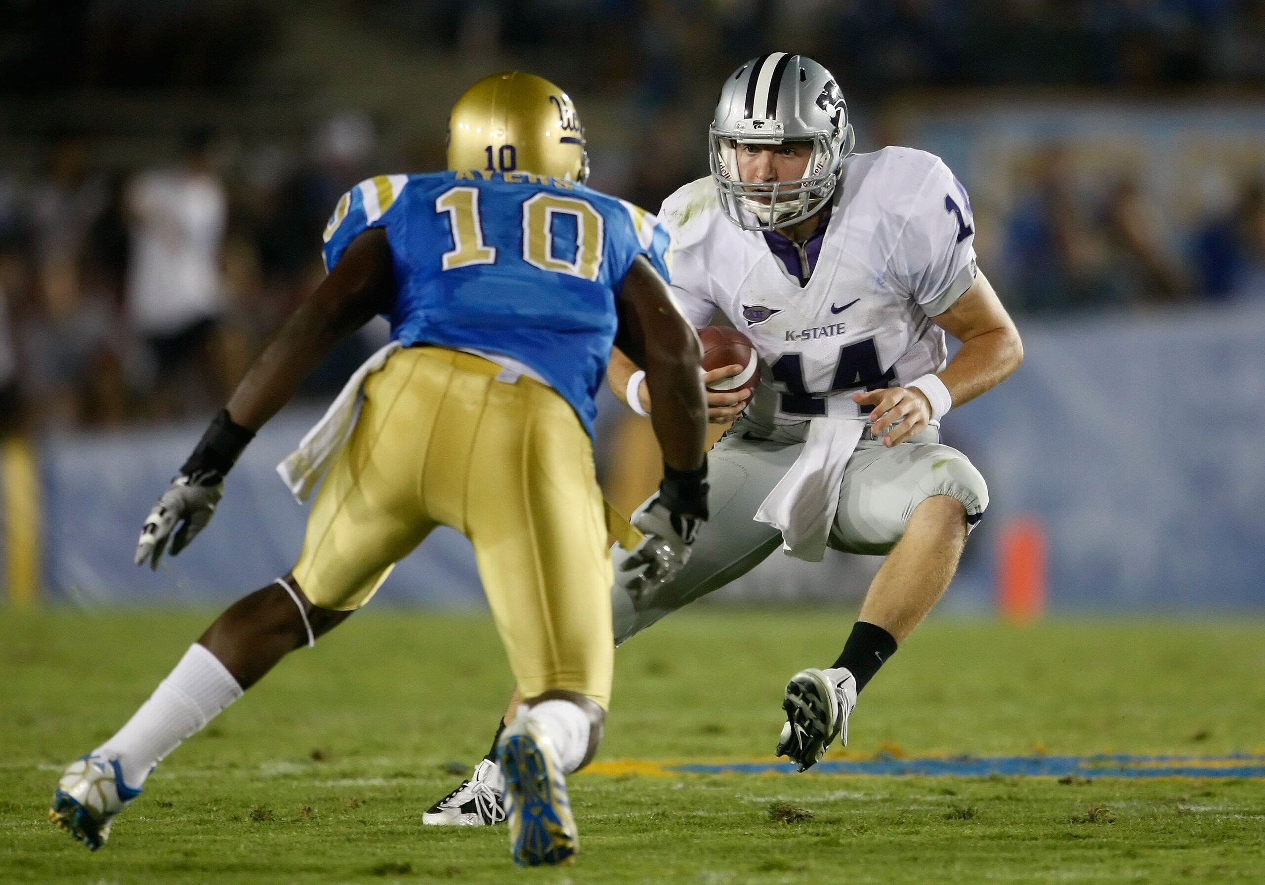 PASADENA, CA - SEPTEMBER 19:  Quarterback Carson Coffman #14 of the Kansas State Wildcats is met by Akeem Ayers #10 of the UCLA Bruins in the first half at the Rose Bowl on September 19, 2009 in Pasadena, California.  (Photo by Jeff Gross/Getty Images)