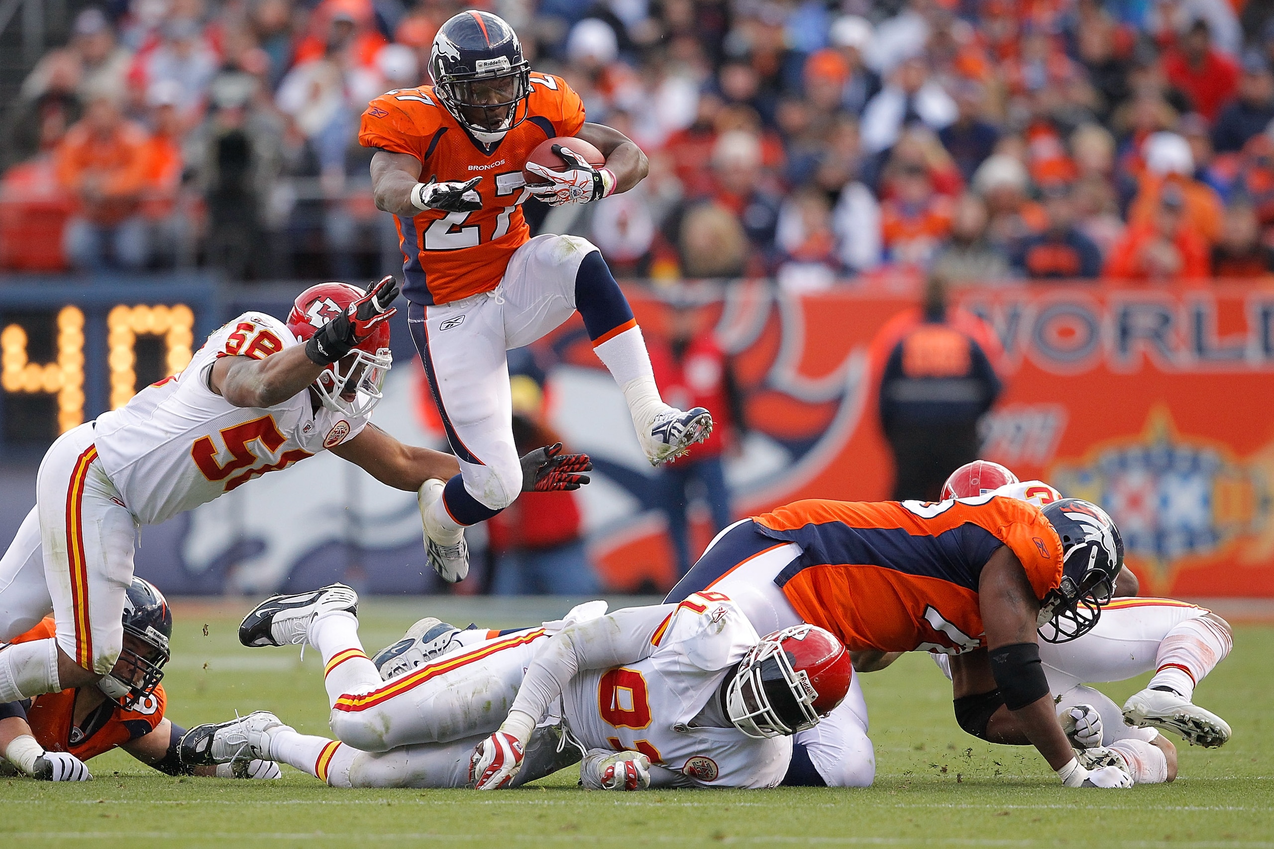 DENVER - NOVEMBER 14: Running back Knowshon Moreno #27 of the Denver Broncos jumps over a pile of defenders and past linebacker Derrick Johnson #56 of the Kansas City Chiefs during the second quarter at INVESCO Field at Mile High on November 14, 2010 in DENVER - NOVEMBER 14: Running back Knowshon Moreno #27 of the Denver Broncos jumps over a pile of defenders and past linebacker Derrick Johnson #56 of the Kansas City Chiefs during the second quarter at INVESCO Field at Mile High on November 14, 2010 in