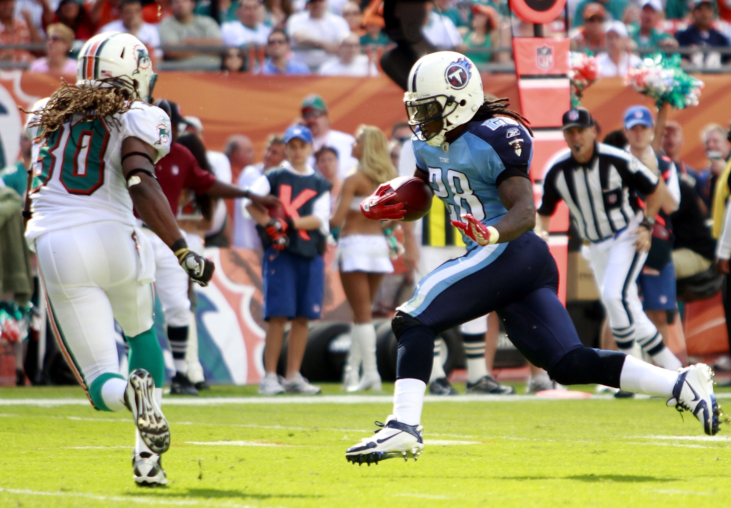 MIAMI - NOVEMBER 14:  Running back Chris Johnson #28 of the Tennessee Titans scores a touchdown  against Chris Clemons #30 of the Miami Dolphins at Sun Life Stadium on November 14, 2010 in Miami, Florida.  (Photo by Marc Serota/Getty Images)