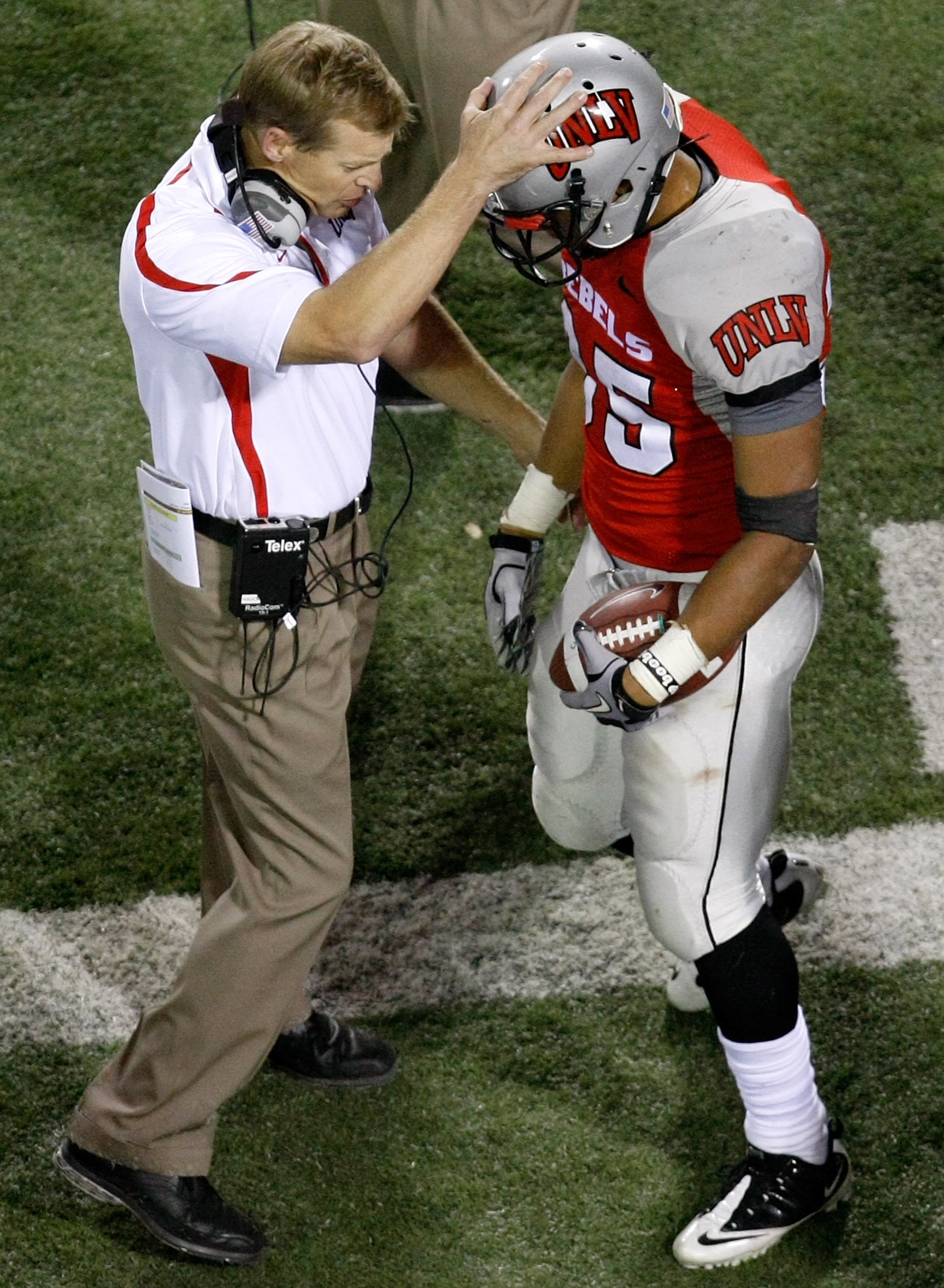 LAS VEGAS - NOVEMBER 13:  Head coach Bobby Hauck of the UNLV Rebels congratulates Tim Cornett #35 after he scored his fourth touchdown against the Wyoming Cowboys at Sam Boyd Stadium November 13, 2010 in Las Vegas, Nevada. UNLV won 42-16.  (Photo by Ethan
