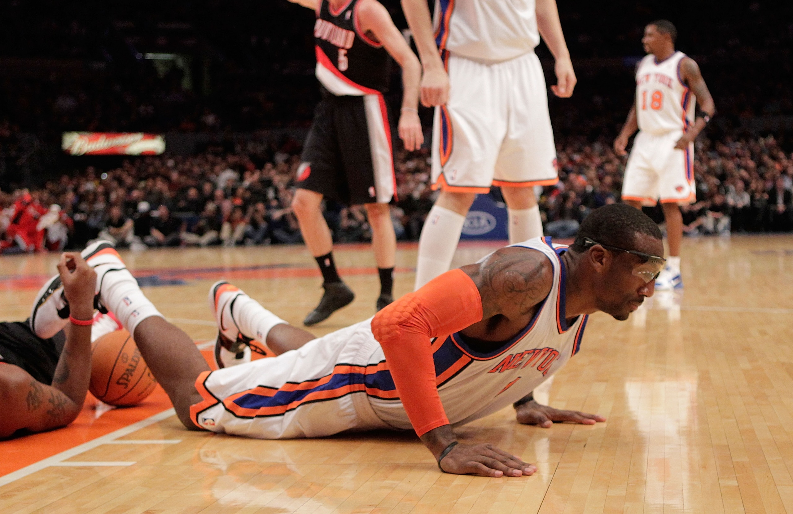 NEW YORK - OCTOBER 30:  Amar'e Stoudemire #1 of the New York Knicks on the ground after being called for a charging foul against the Portland Trail Blazers at Madison Square Garden on October 30, 2010 in New York City. NOTE TO USER: User expressly acknowl