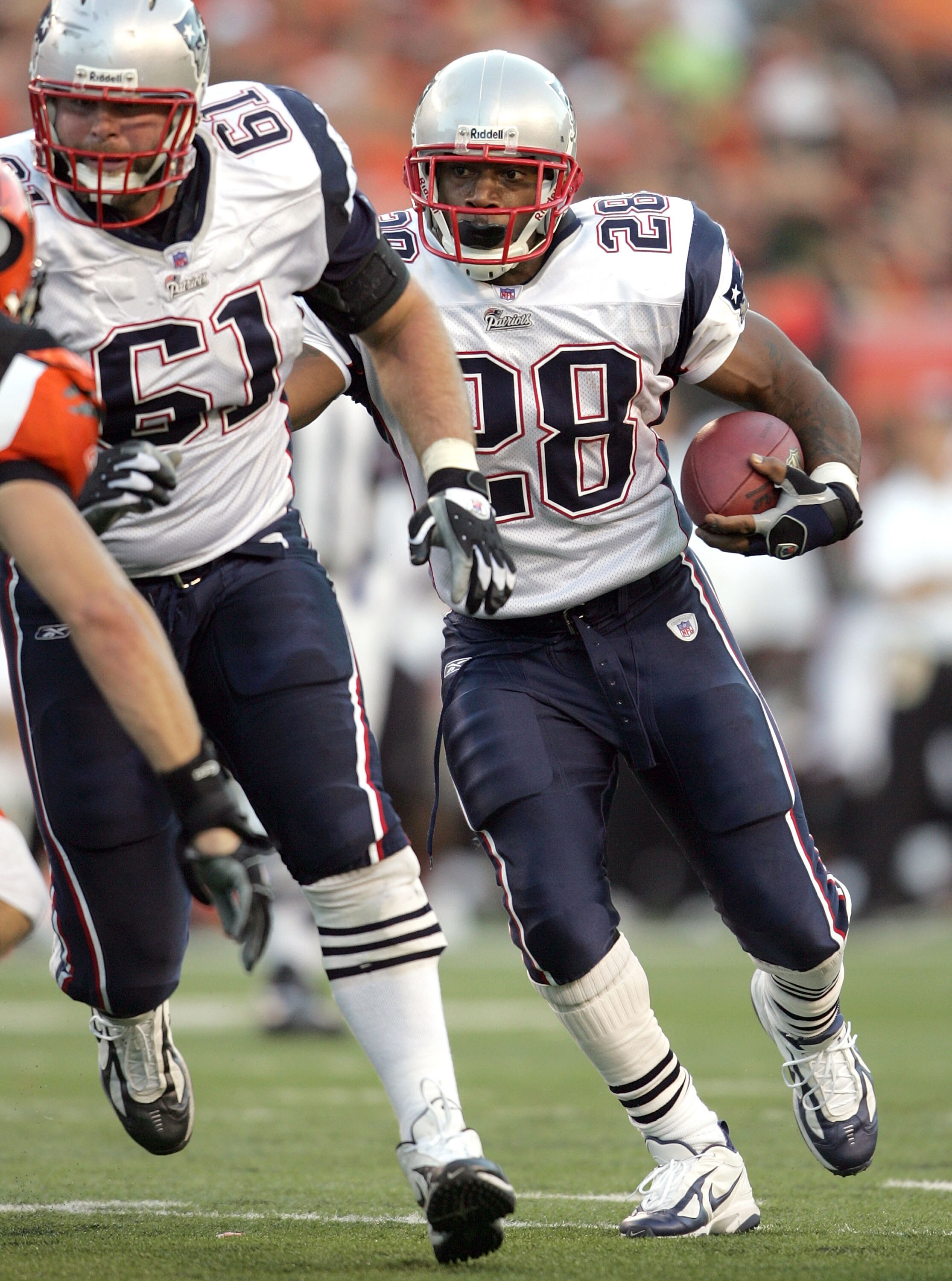 CINCINNATI - OCTOBER 1:  Corey Dillon #28 of the New England Patriots runs for a touchdown behind the blocking of guard Steve Neal #61 during the NFL game against the Cincinnati Bengals on October 1, 2006 at Paul Brown Stadium in Cincinnati, Ohio. The Pat