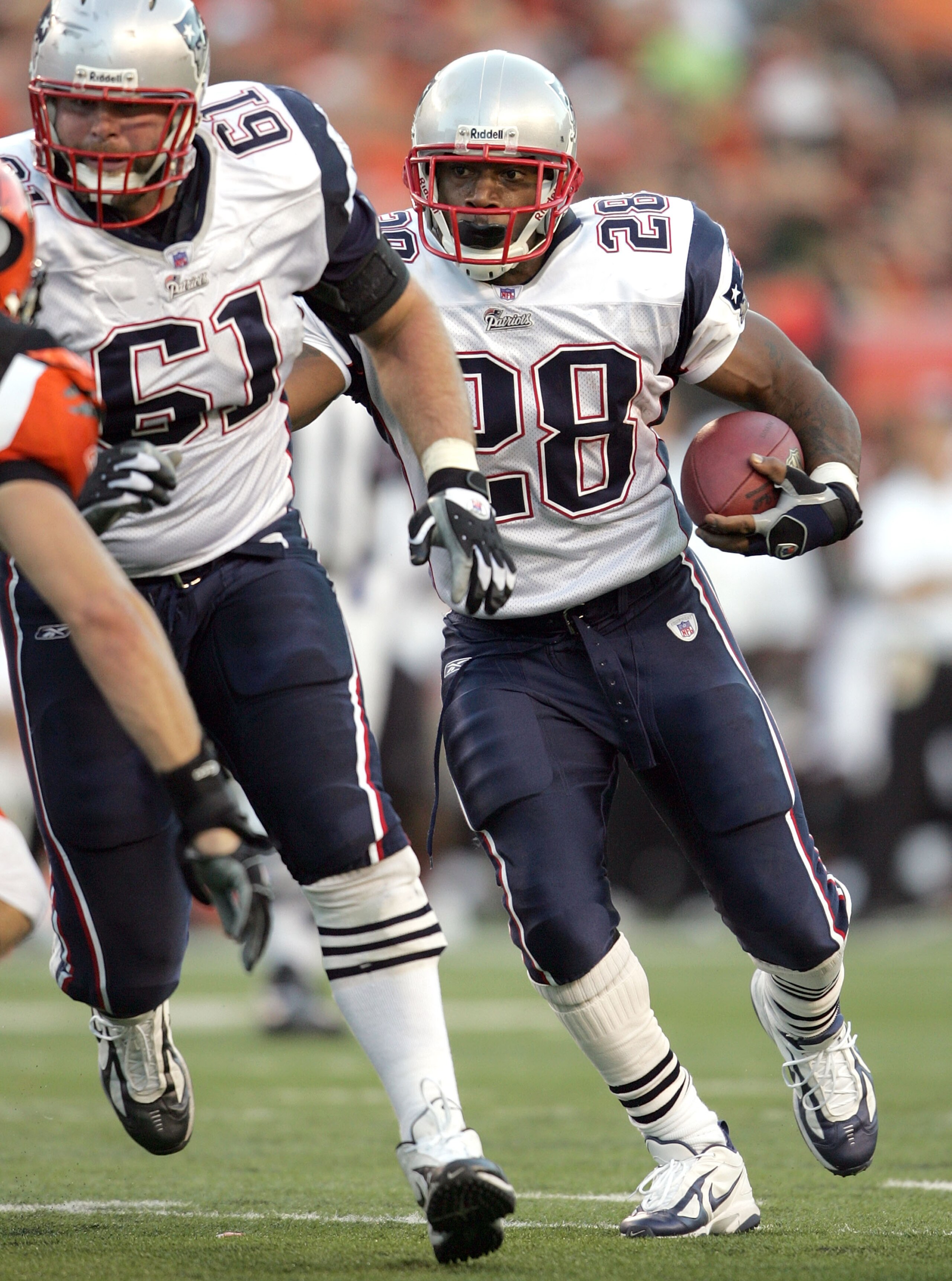 CINCINNATI - OCTOBER 1:  Corey Dillon #28 of the New England Patriots runs for a touchdown behind the blocking of guard Steve Neal #61 during the NFL game against the Cincinnati Bengals on October 1, 2006 at Paul Brown Stadium in Cincinnati, Ohio. The Pat