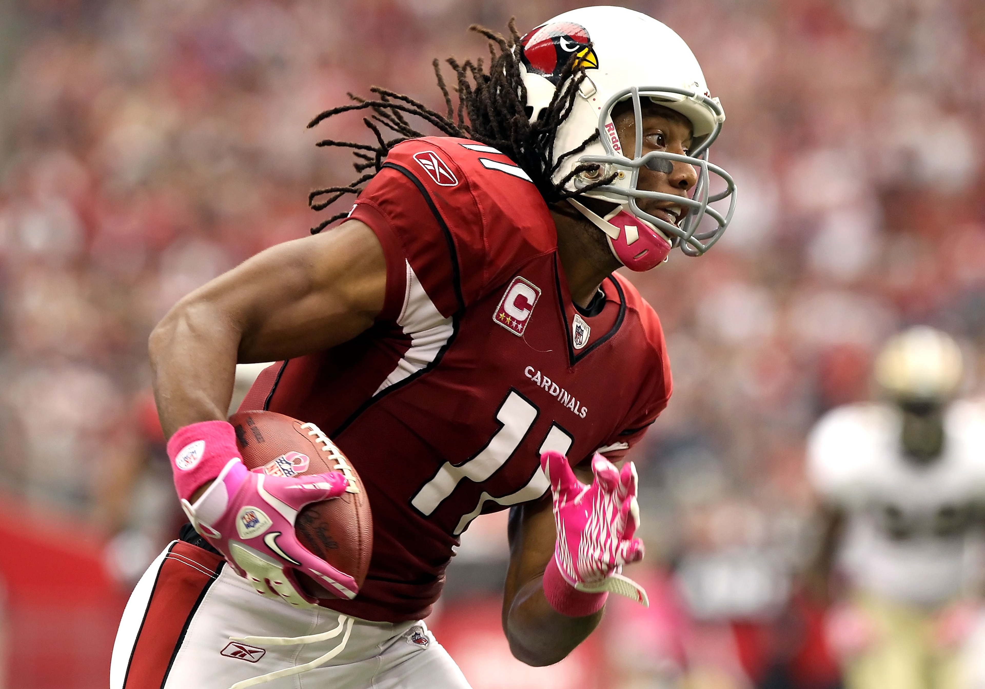 GLENDALE, AZ - OCTOBER 10:  Wide receiver Larry Fitzgerald #11 of the Arizona Cardinals runs with the football after a reception against the New Orleans Saints during the NFL game at the University of Phoenix Stadium on October 10, 2010 in Glendale, Arizo