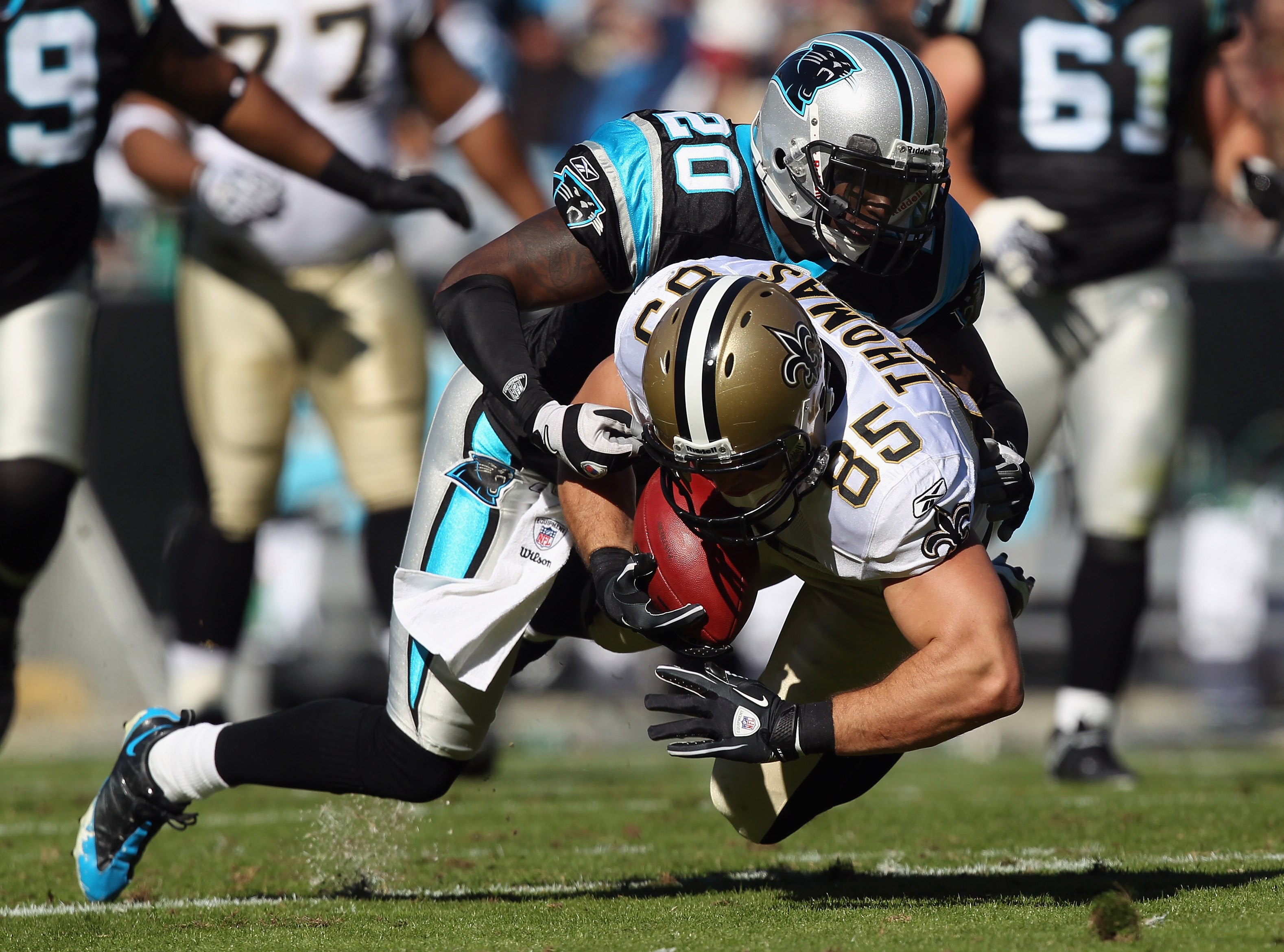 CHARLOTTE, NC - NOVEMBER 07:  David Thomas #85 of the New Orleans Saints is tackled by Chris Gamble #20 of the Carolina Panthers during their game at Bank of America Stadium on November 7, 2010 in Charlotte, North Carolina.  (Photo by Streeter Lecka/Getty