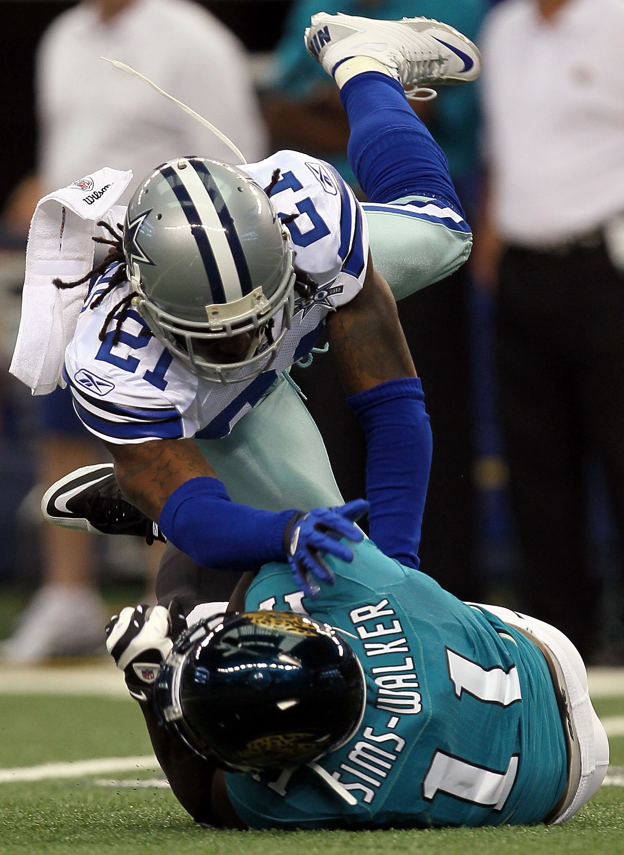 ARLINGTON, TX - OCTOBER 31:  Wide receiver Mike Sims-Walker #11 of the Jacksonville Jaguars is tackled by Mike Jenkins #21 of the Dallas Cowboys at Cowboys Stadium on October 31, 2010 in Arlington, Texas.  (Photo by Stephen Dunn/Getty Images)