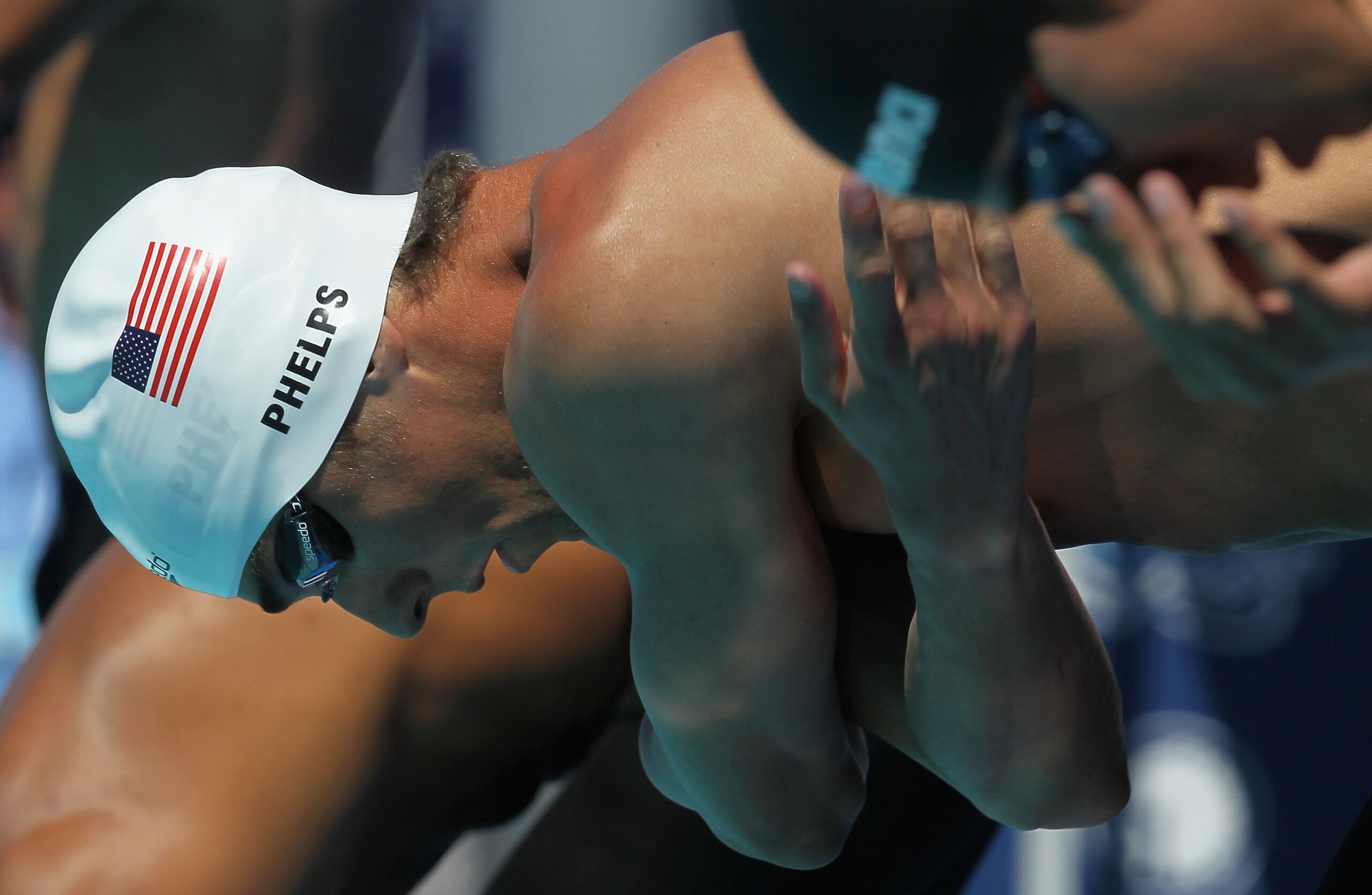 IRVINE, CA - AUGUST 20:  Michael Phelps gets set on the blocks for his the men's 100m butterfly qualifying heat during the Mutual of Omaha Pan Pacific Championships at the William Woollett Jr. Aquatic Center on August 20, 2010 in Irvine, California.  (Pho