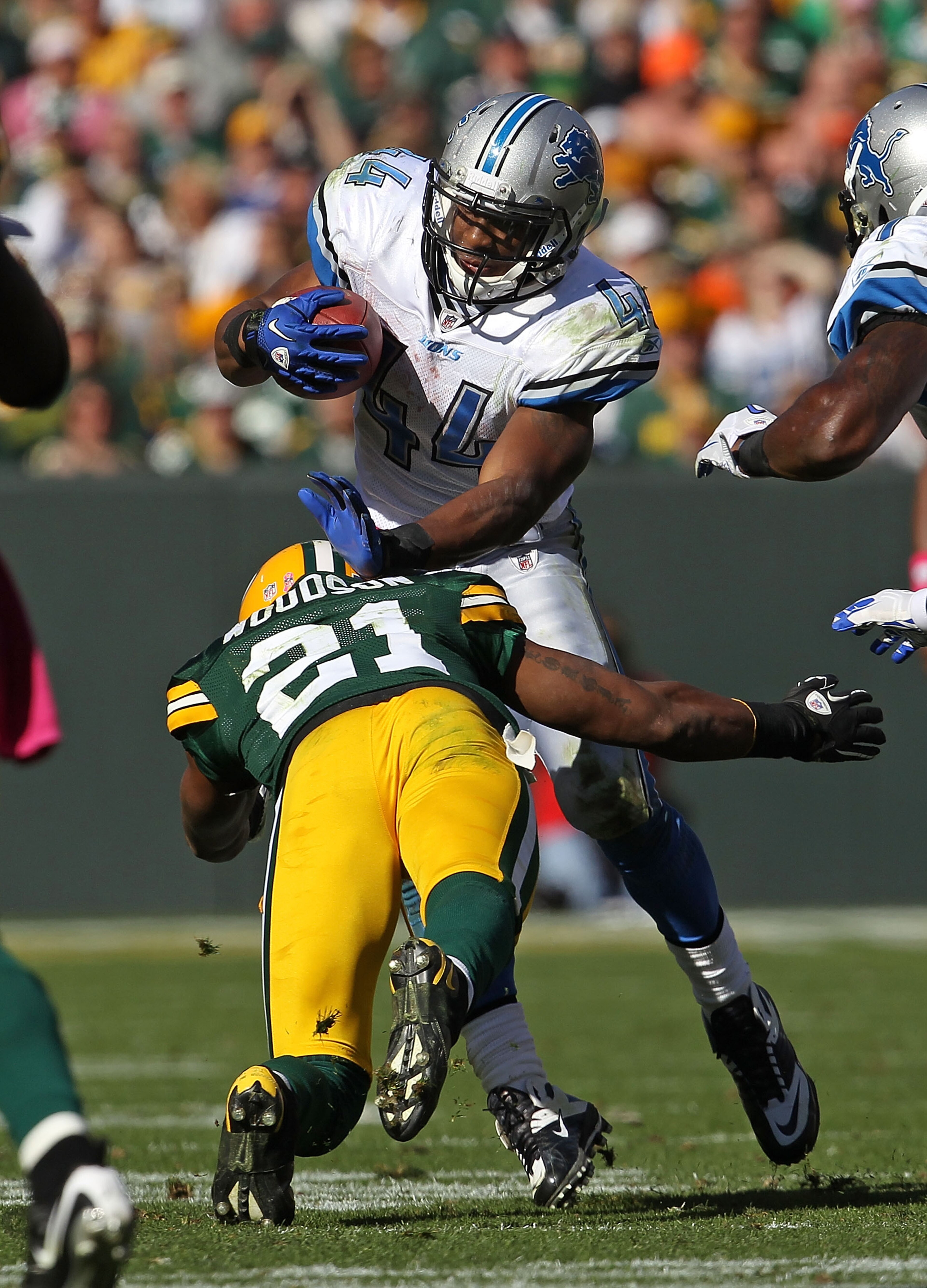 GREEN BAY, WI - OCTOBER 03: Rahvid Best #44 of the Detroit Lions is tackled by Charles Woodson #21 of the Green Bay Packers at Lambeau Field on October 3, 2010 in Green Bay, Wisconsin. The Packers defeated the Lions 28-26. (Photo by Jonathan Daniel/Getty GREEN BAY, WI - OCTOBER 03: Rahvid Best #44 of the Detroit Lions is tackled by Charles Woodson #21 of the Green Bay Packers at Lambeau Field on October 3, 2010 in Green Bay, Wisconsin. The Packers defeated the Lions 28-26. (Photo by Jonathan Daniel/Getty