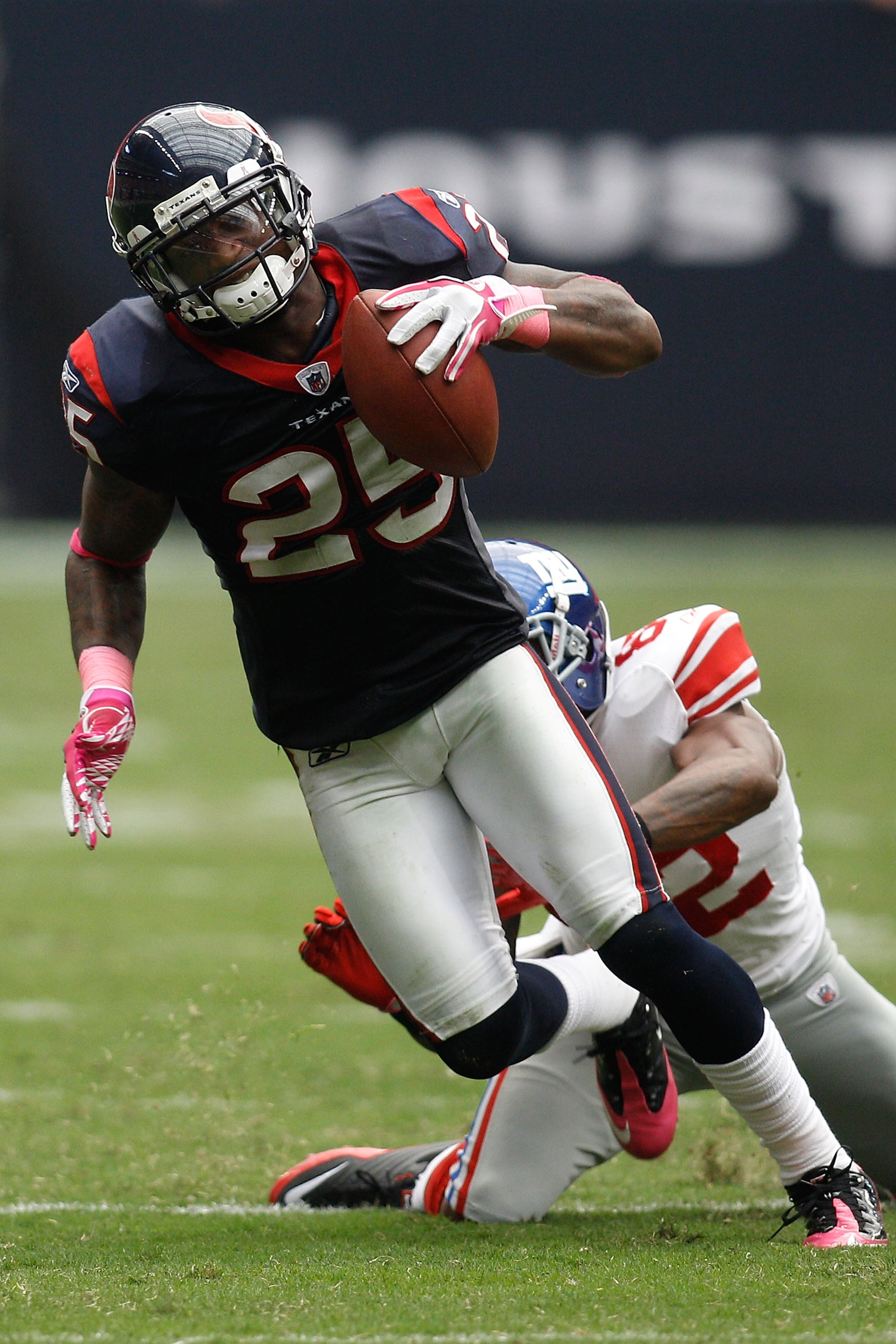 HOUSTON - OCTOBER 10: Kareem Jackson #25 of the Houston Texans avoids a tackle after intercepting a pass by Mario Manningham #82 of the New York Giants at Reliant Stadium on October 10, 2010 in Houston, Texas. The Giants defeated the Texans 34-10. (Ph HOUSTON - OCTOBER 10: Kareem Jackson #25 of the Houston Texans avoids a tackle after intercepting a pass by Mario Manningham #82 of the New York Giants at Reliant Stadium on October 10, 2010 in Houston, Texas. The Giants defeated the Texans 34-10. (Ph