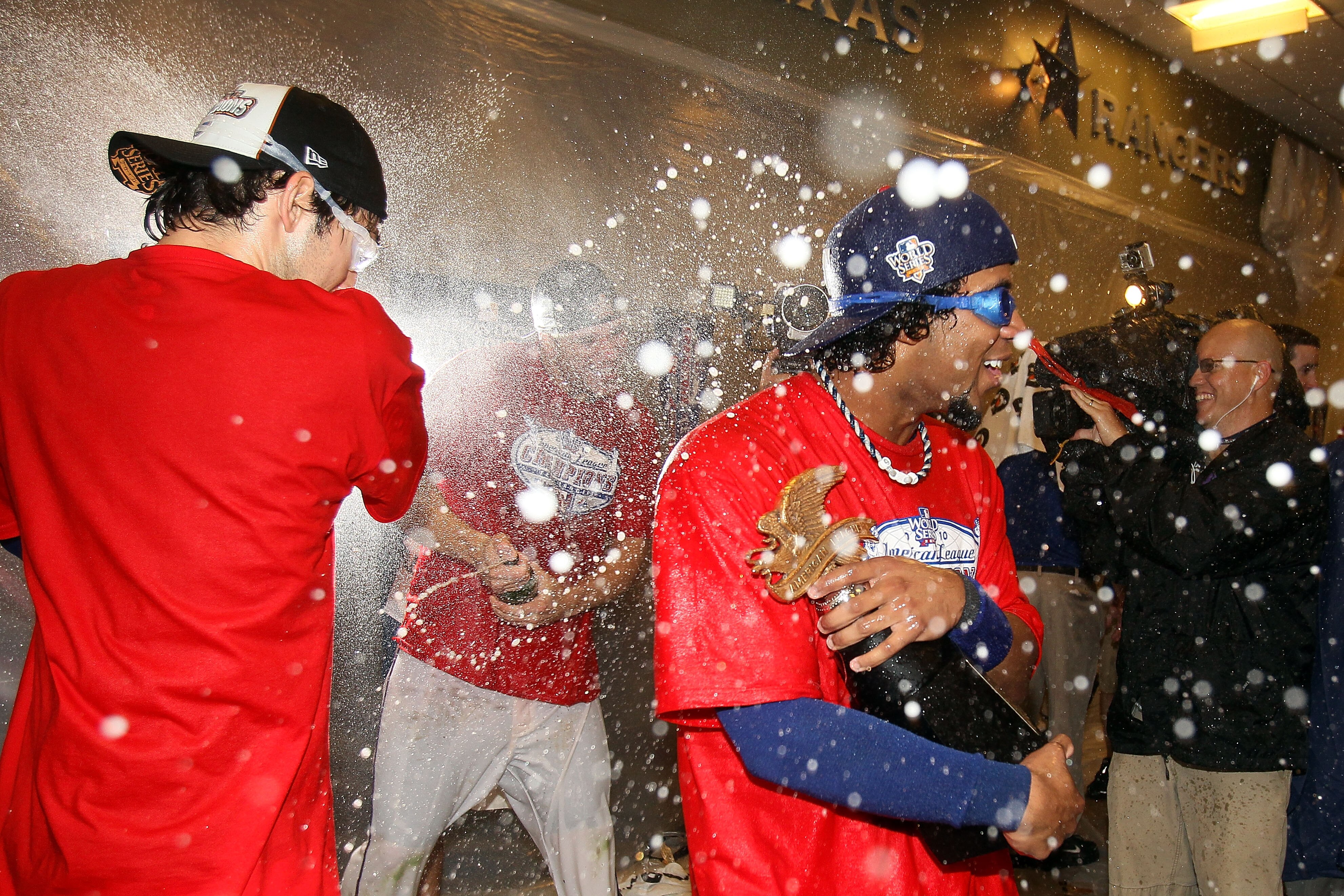 ARLINGTON, TX - OCTOBER 22:  Elvis Andrus #1 of the Texas Rangers celebrates with the trophy in the lockerroom after the Rangers won 6-1 aganst the New York Yankees in Game Six of the ALCS during the 2010 MLB Playoffs at Rangers Ballpark in Arlington on O