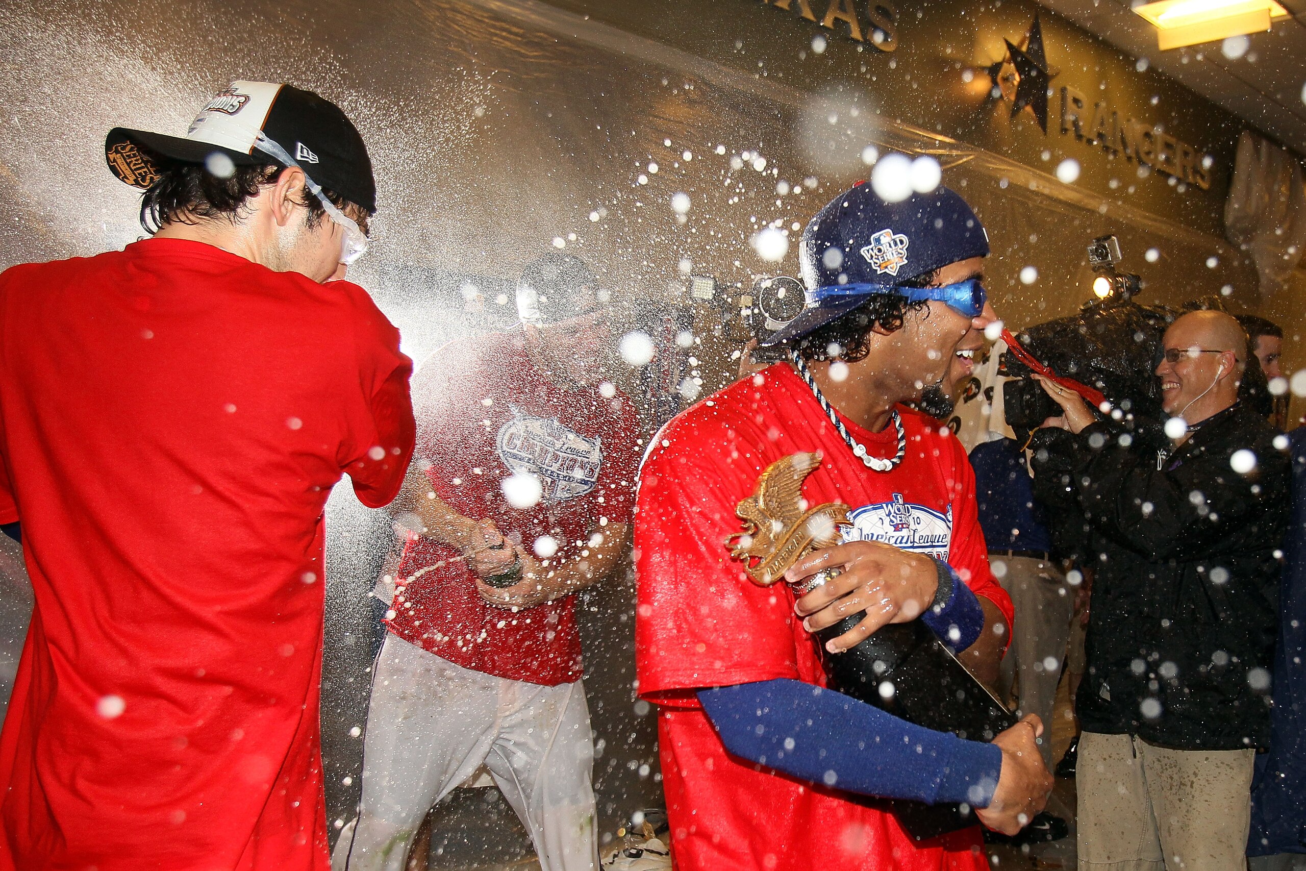 ARLINGTON, TX - OCTOBER 22:  Elvis Andrus #1 of the Texas Rangers celebrates with the trophy in the lockerroom after the Rangers won 6-1 aganst the New York Yankees in Game Six of the ALCS during the 2010 MLB Playoffs at Rangers Ballpark in Arlington on O