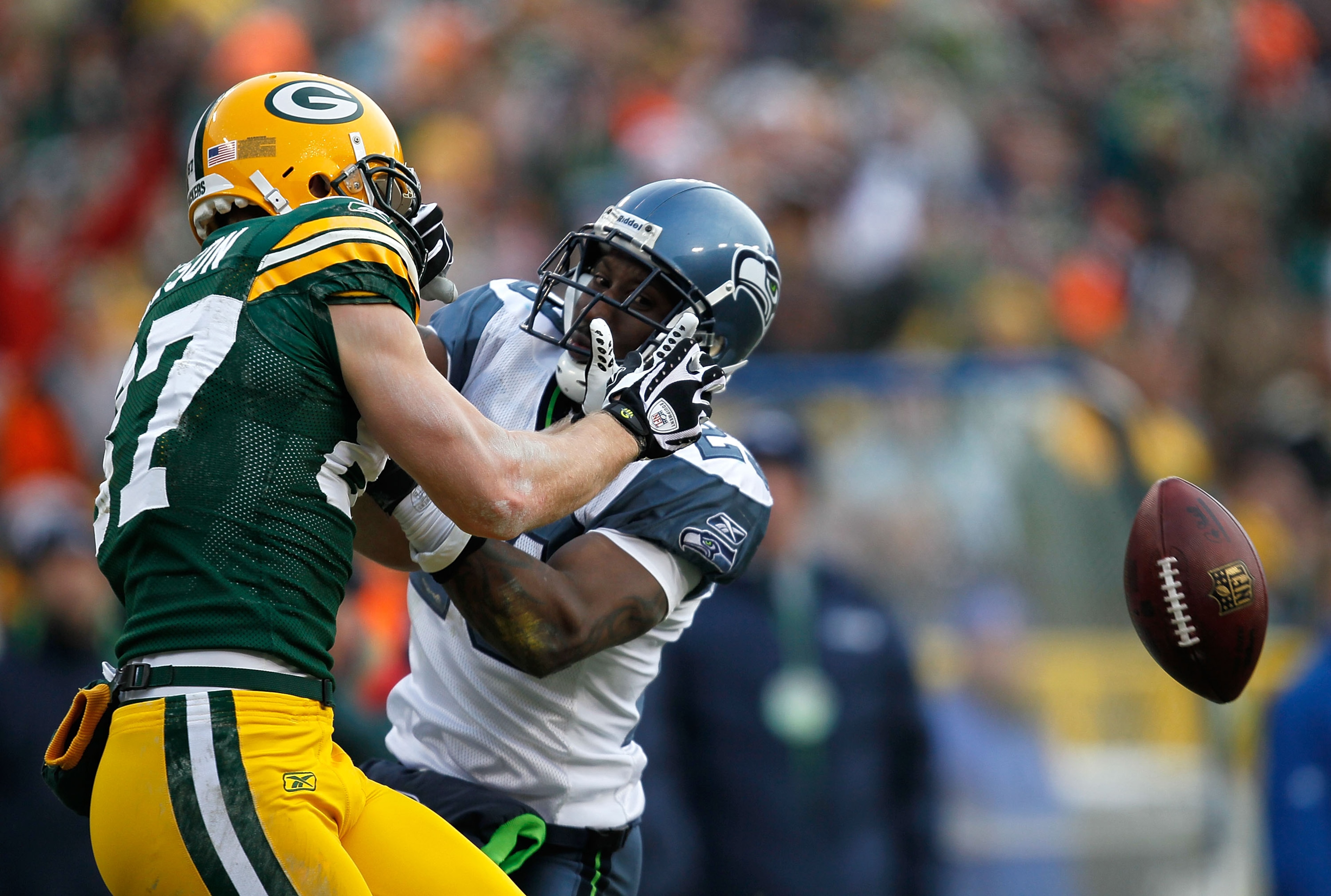GREEN BAY, WI - DECEMBER 27: Marcus Trufant #23 of the Seattle Seahawks interfers with a catch attempt by Jordy Nelson #87 of the Green Bay Packers at Lambeau Field on December 27, 2009 in Green Bay, Wisconsin. The Packers defeated the Seahawks 48-10. (Ph GREEN BAY, WI - DECEMBER 27: Marcus Trufant #23 of the Seattle Seahawks interfers with a catch attempt by Jordy Nelson #87 of the Green Bay Packers at Lambeau Field on December 27, 2009 in Green Bay, Wisconsin. The Packers defeated the Seahawks 48-10. (Ph