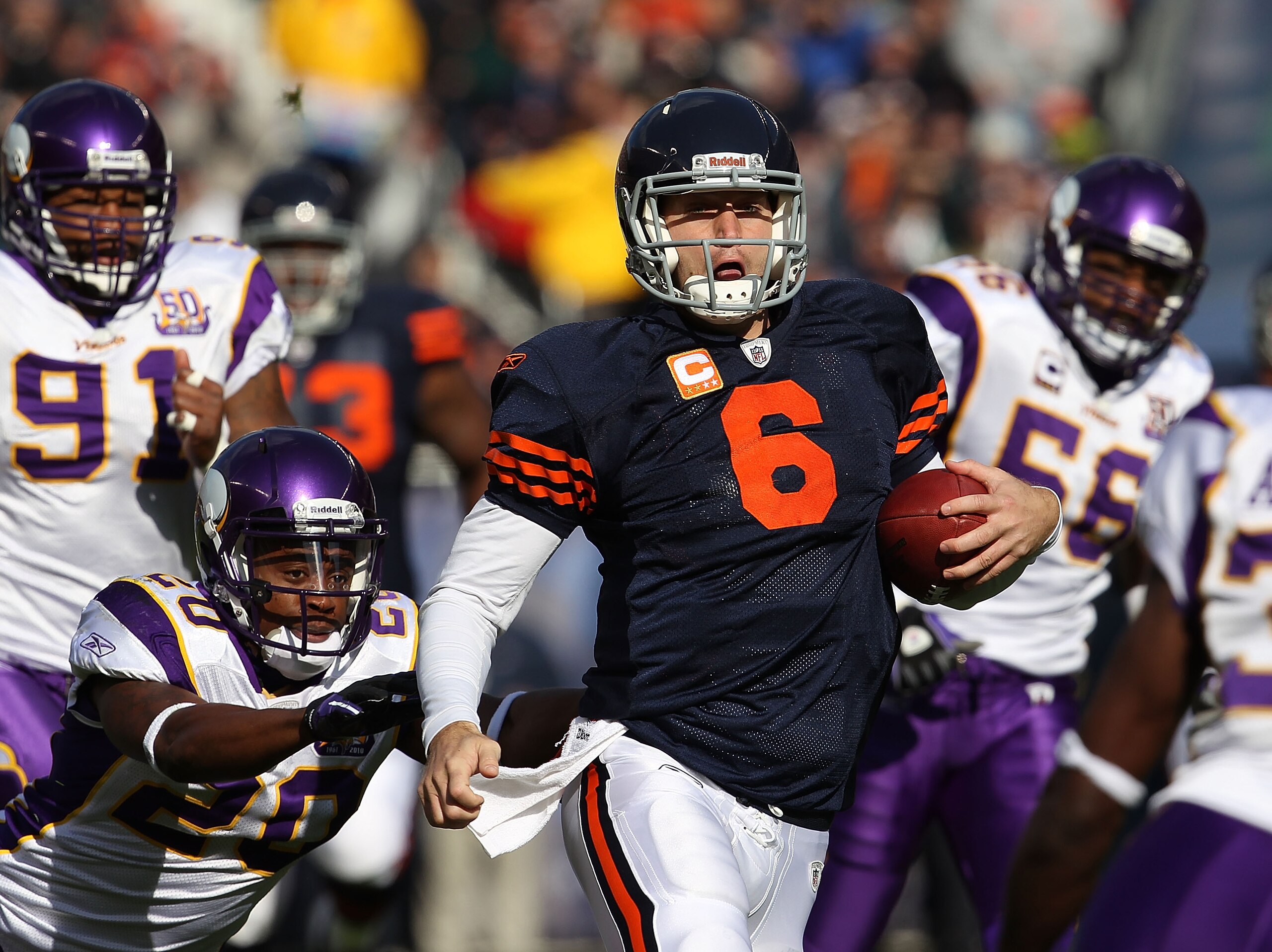 CHICAGO - NOVEMBER 14: Jay Cutler #6 of the Chicago Bears runs for a first down as Ray Edwards #91 and Madieu Williams #20 of the Minnesota Vikings give chase at Soldier Field on November 14, 2010 in Chicago, Illinois. The Bears defeated the Vikings 27-13