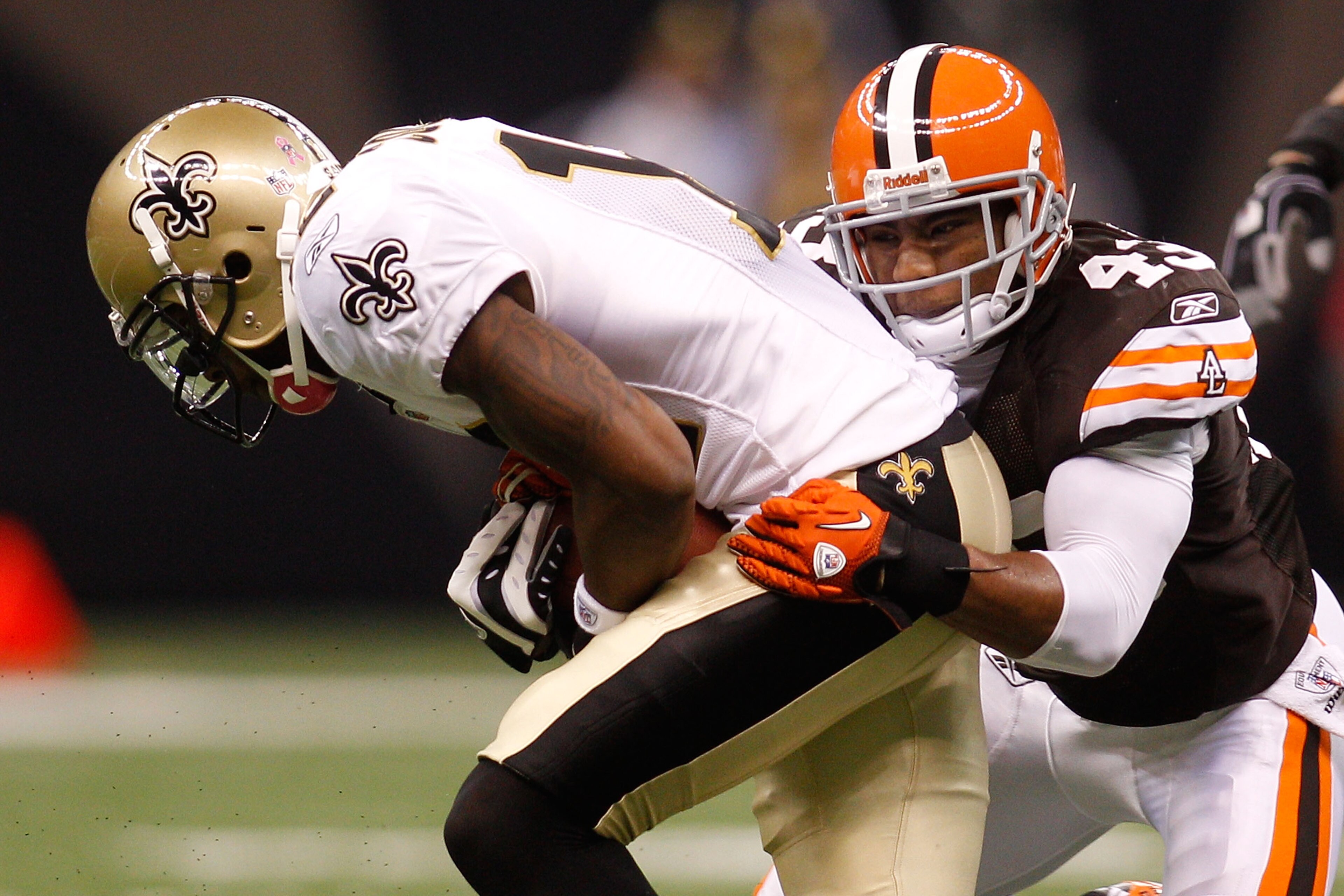 NEW ORLEANS - OCTOBER 24: Marques Colston #12 of the New Orleans Saints is tackled by T.J. Ward #43 of the Cleveland Browns at the Louisiana Superdome on October 24, 2010 in New Orleans, Louisiana. (Photo by Chris Graythen/Getty Images) NEW ORLEANS - OCTOBER 24: Marques Colston #12 of the New Orleans Saints is tackled by T.J. Ward #43 of the Cleveland Browns at the Louisiana Superdome on October 24, 2010 in New Orleans, Louisiana. (Photo by Chris Graythen/Getty Images)