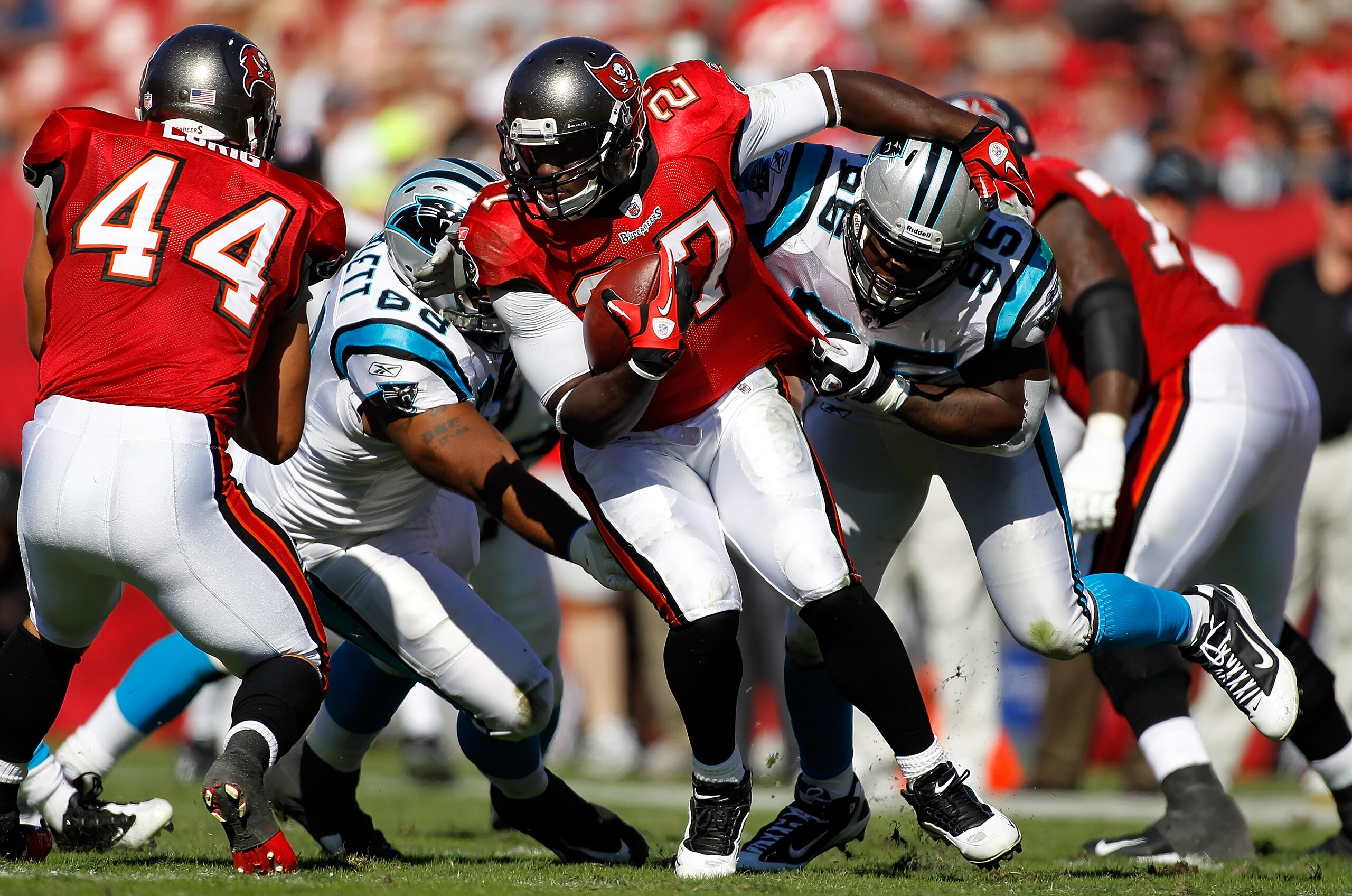 TAMPA, FL - NOVEMBER 14:  Running back LeGarrette Blount #27 of the Tampa Bay Buccaneers is tackled by defender Charles Johnson #95 of the Carolina Panthers during the game at Raymond James Stadium on November 14, 2010 in Tampa, Florida.  (Photo by J. Mer