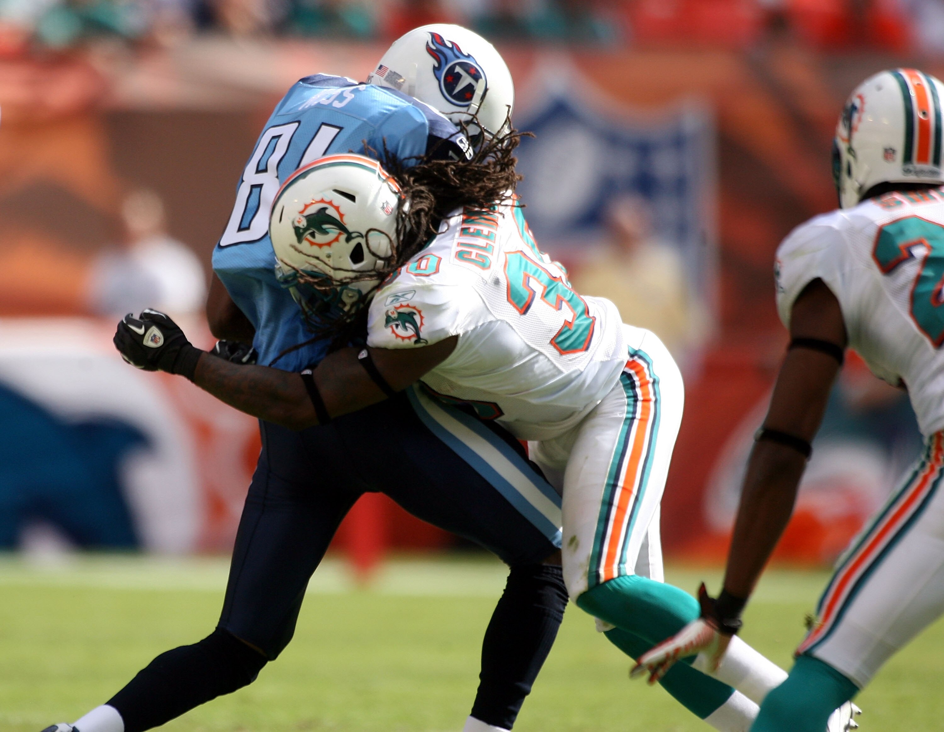 MIAMI - NOVEMBER 14:  Receiver Randy Moss #84 of the Tennessee Titans is hit by Chris Clemons of the Miami Dolphins at Sun Life Stadium on November 14, 2010 in Miami, Florida.  (Photo by Marc Serota/Getty Images)