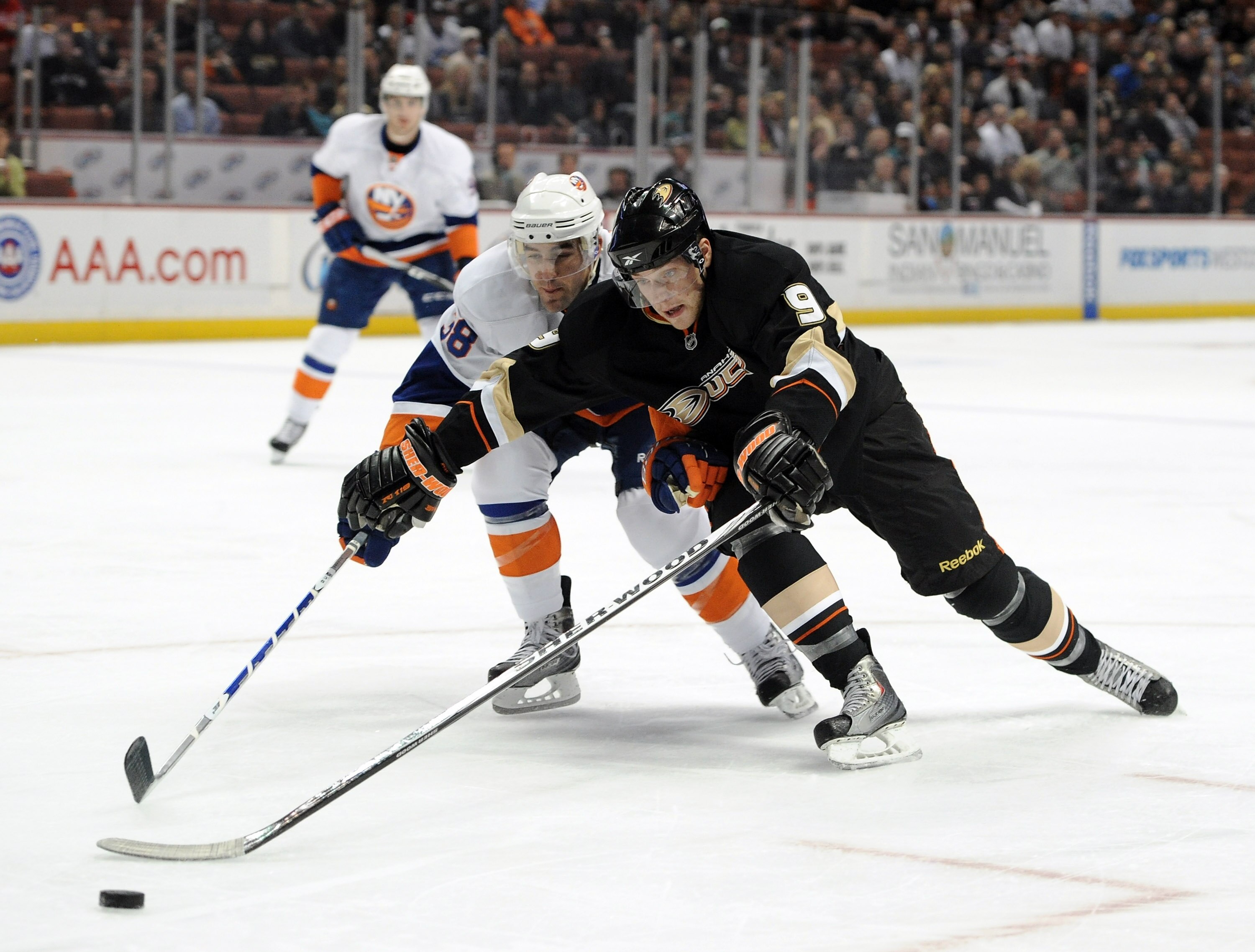 ANAHEIM, CA - NOVEMBER 10:  Bobby Ryan #9 of the Anaheim Ducks attempts to get around Jack Hillen #38 of the New York Islanders at the Honda Center on November 10, 2010 in Anaheim, California.  (Photo by Harry How/Getty Images)
